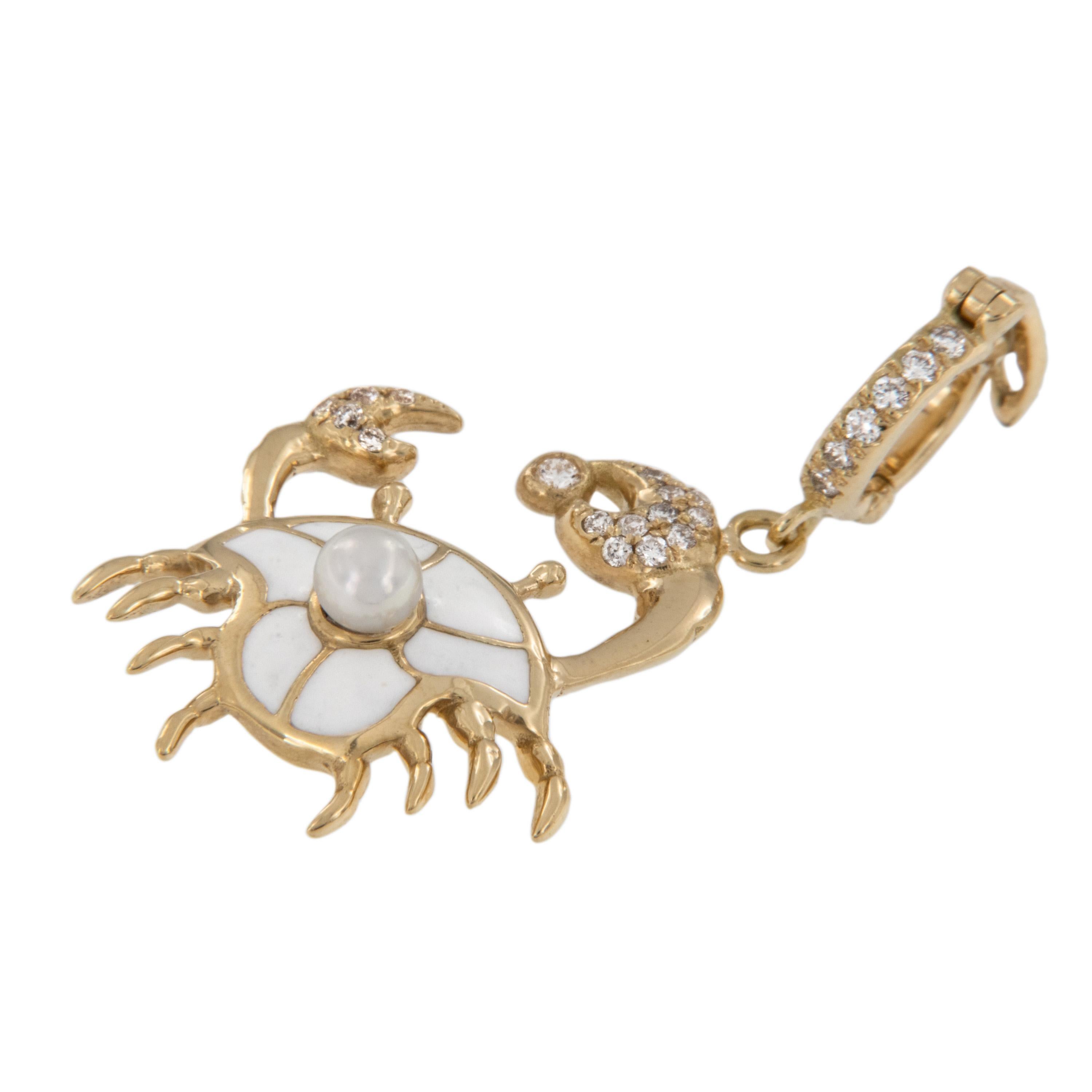 Crafted in rich 18 karat yellow gold this adorable crab with white enamel, pearl back and 0.12 Cttw white diamond encrusted claws and bail which is hinged making it easy to wear with your favorite chain or bracelet, or check out our extensive