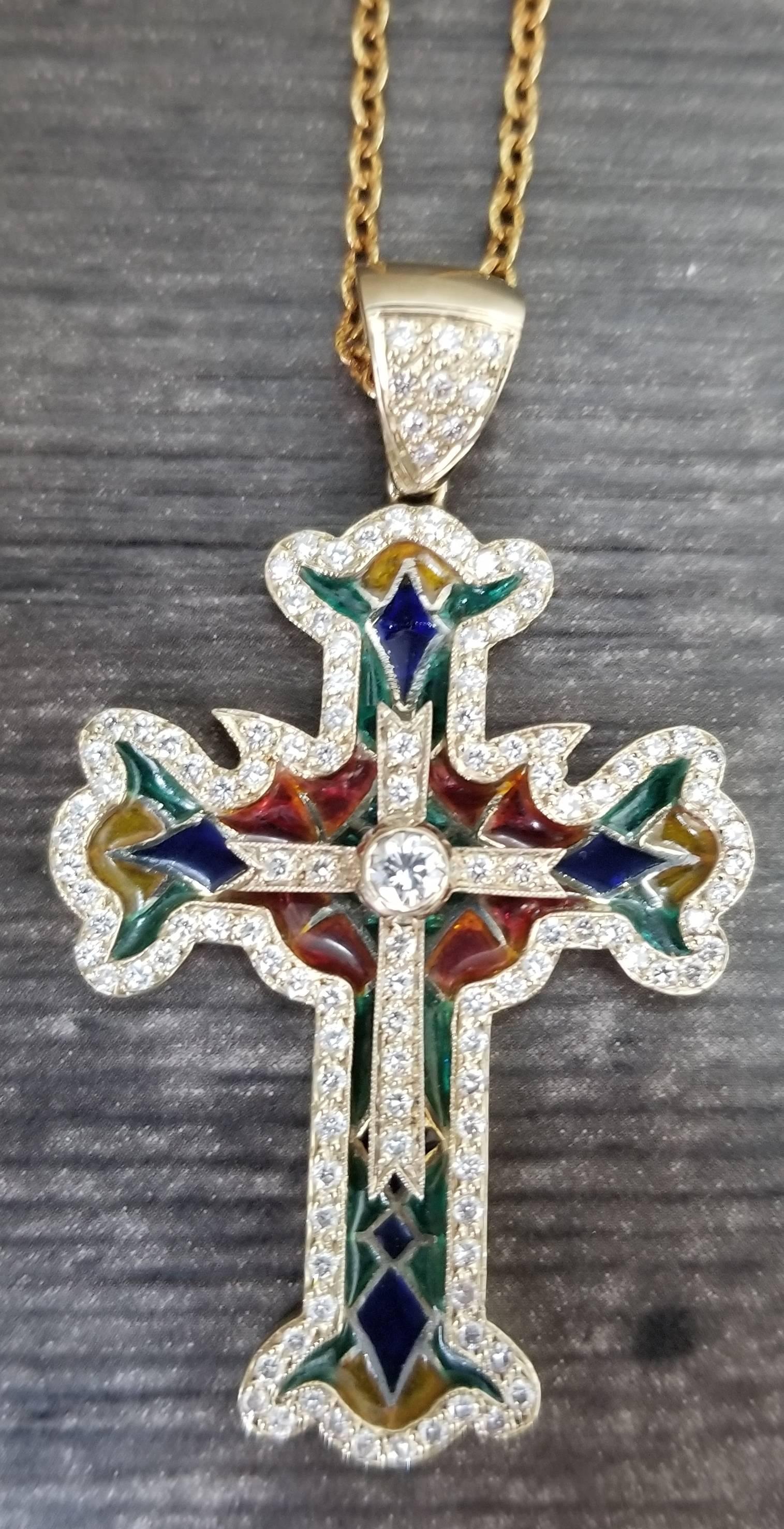 18k yellow gold enamel and diamond cross, containing 129 round full cut diamonds weighing 1.50ct. with multi colored enamel on a 24 inch beaded link chain.