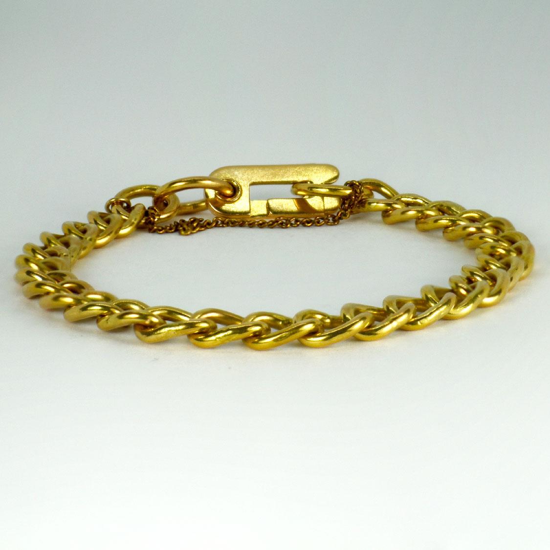 An 18 karat (18K) yellow gold bracelet designed as a curb link chain with faceted links. Unmarked but tested as 18 karat gold. Gold plated safety chain attached. 8” long.

Dimensions: 20 x 0.7 cm
Weight: 28.54 grams
