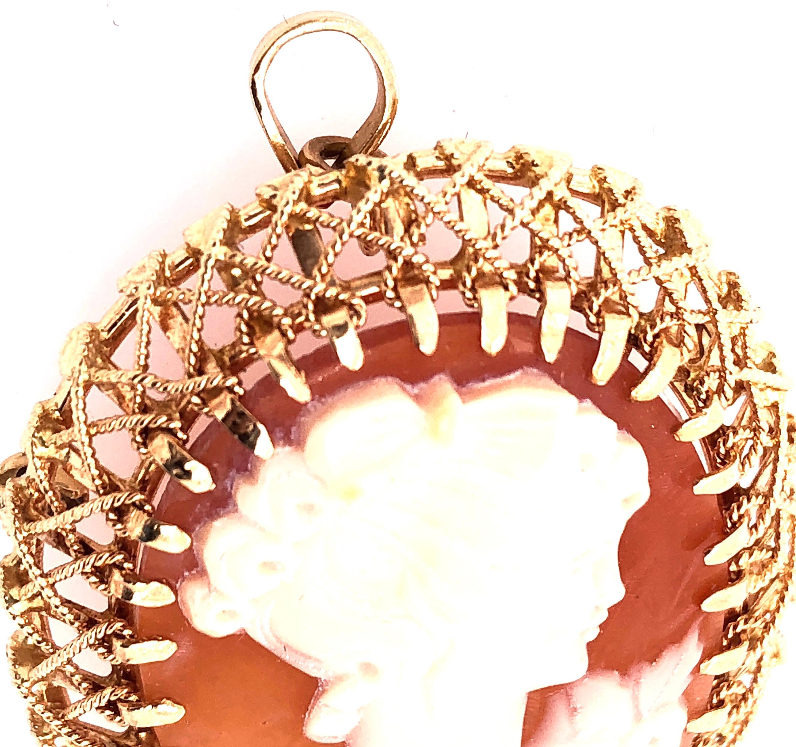 18 Karat Yellow Gold Filigree Design With Woman's Profile Cameo Pendant
10.6 grams total weight.
Height: 40 mm
Width: 30 mm