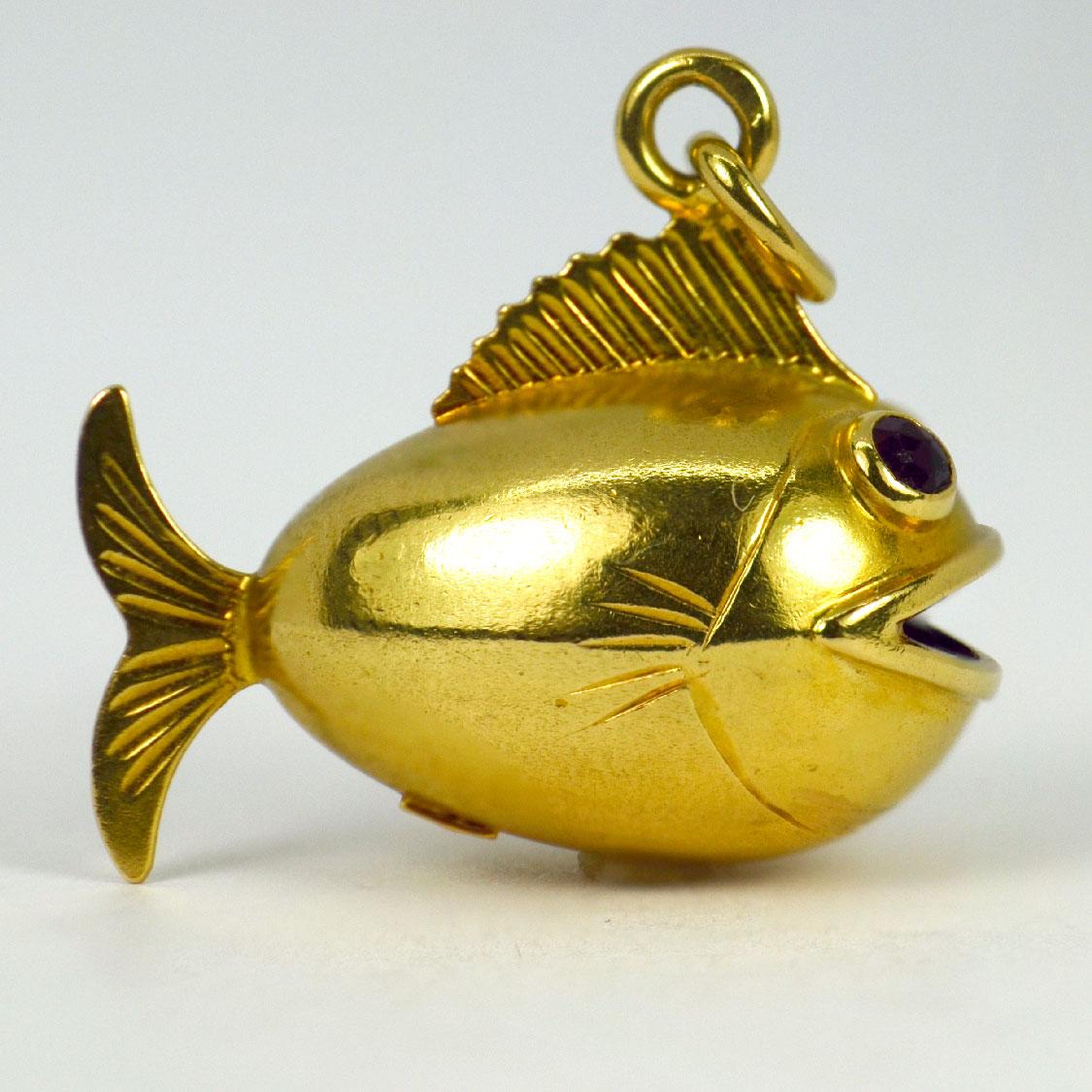 An 18 karat (18K) yellow gold charm pendant designed as a fish with faceted red paste eyes. Stamped with the owl mark for French import and 18 karat gold, and marked 750 and JDB (unknown maker) to a plaque.

Dimensions: 1.9 x 2.1 x 1.2 cm (not