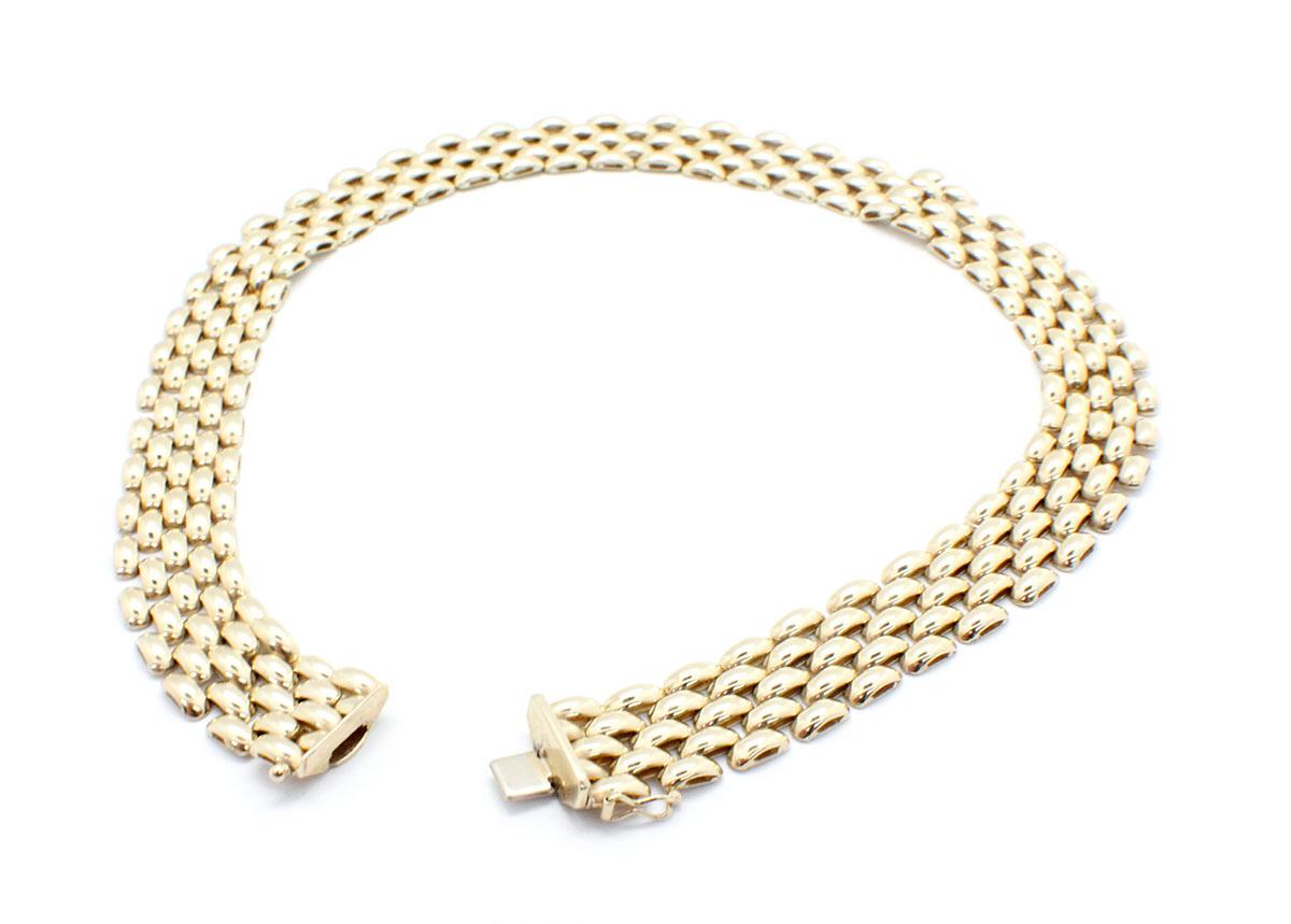 This 18k yellow gold necklace is designed with panther-style links. The necklace is 5 links wide, measuring 16mm wide. The piece measures 16 inches in length and weighs 55.24 grams. The necklace’s closure is secured by a figure eight safety clasp.