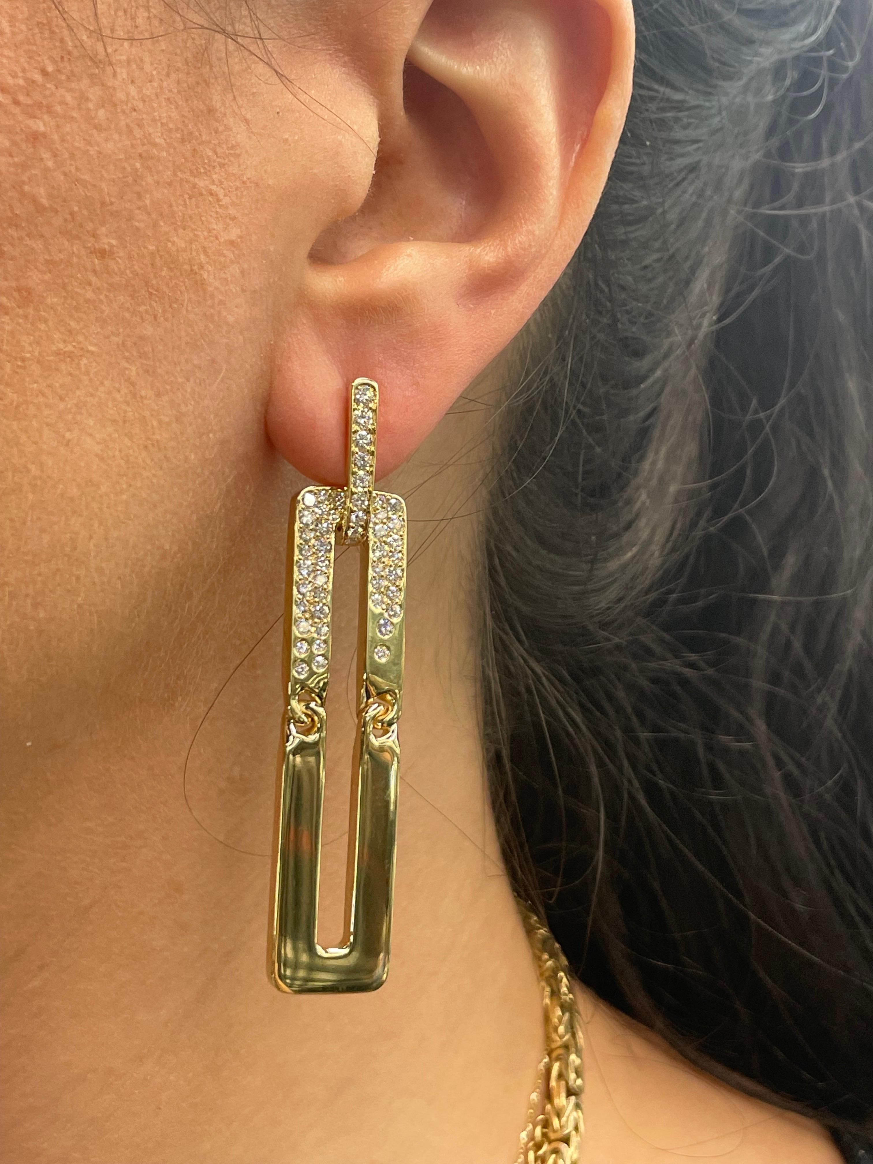 18 Karat Yellow Gold drop earrings featuring floating motif round brilliants weighing 1.80 Carats, 21.8 Grams.
Made in Italy 