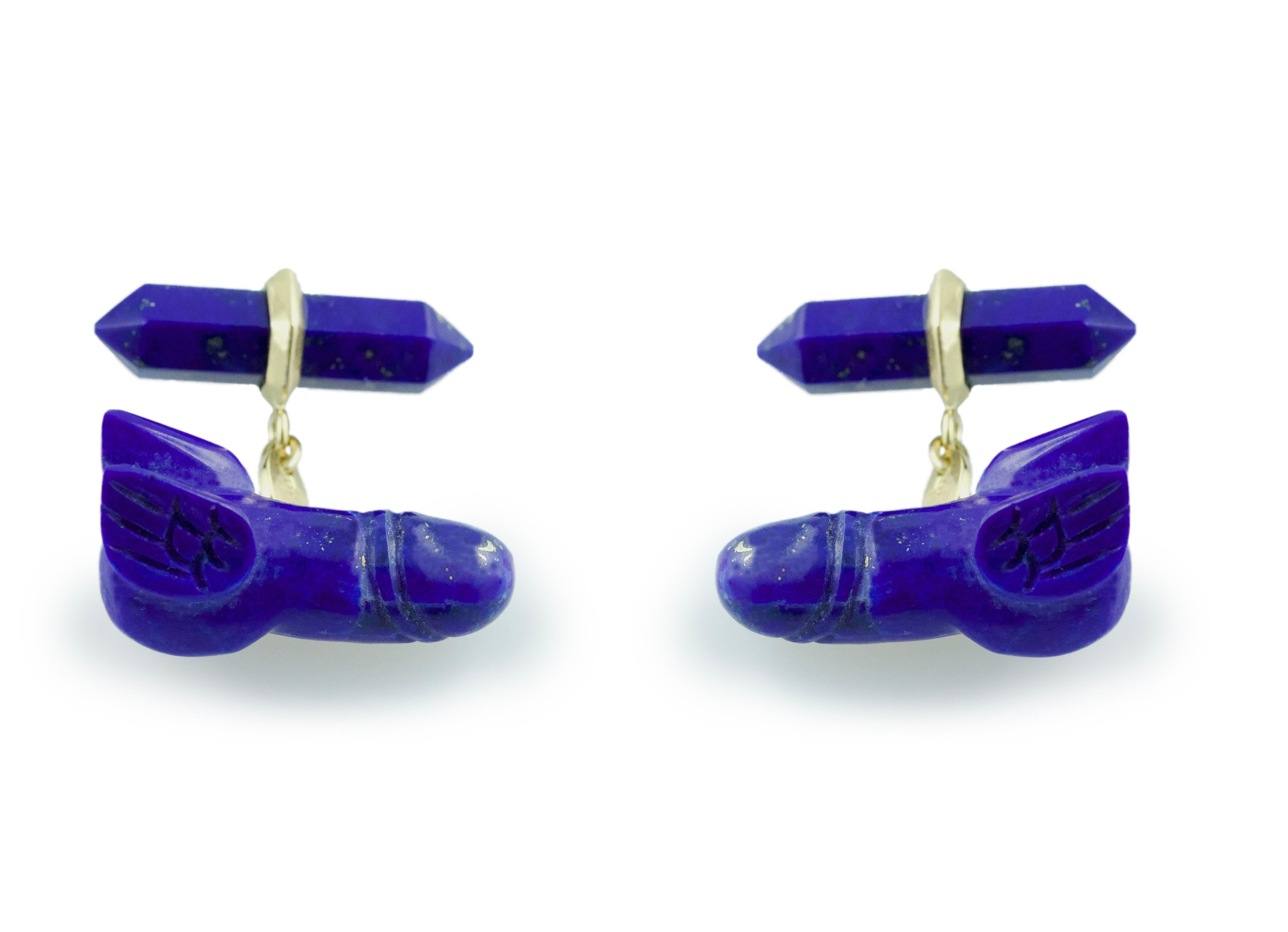 This playful pair of cufflinks is made entirely in lapis lazuli. 
The toggle is a simple elongated hexagon with a post in 18k yellow gold, while the protagonist of the piece is shaped to depict a phallus extravagantly accessorized with a pair of