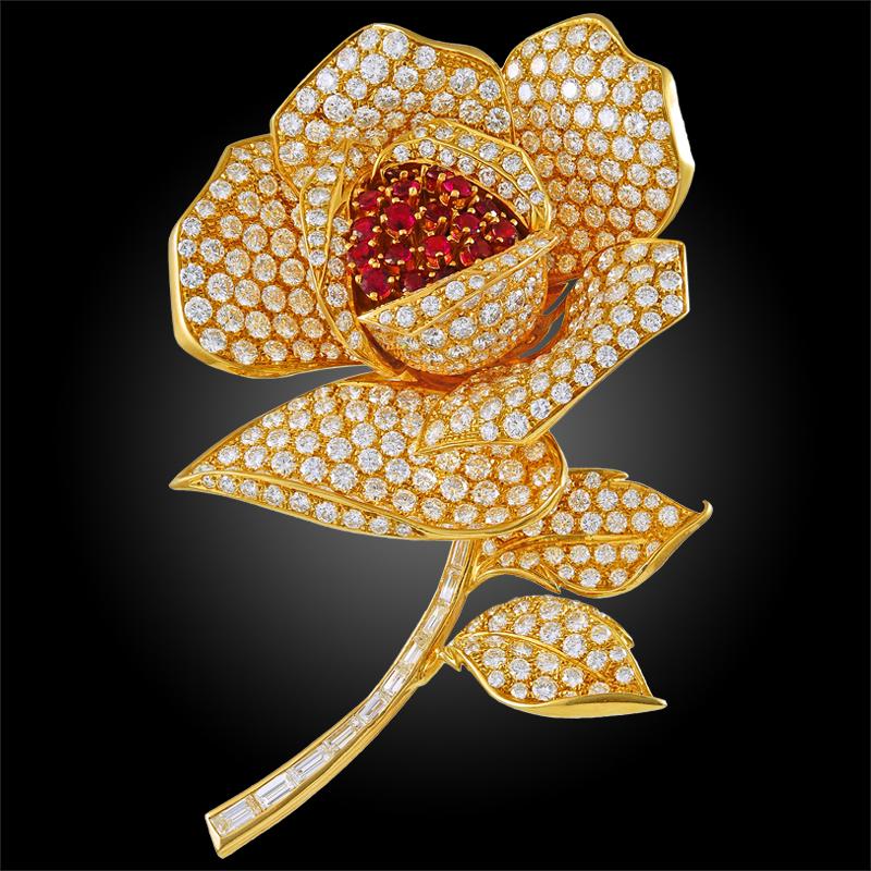 An exceptional and unique brooch that dates back to the 1980s, designed as a flower motif with an interchangeable pistil. The brooch is set in 18k yellow gold, thoroughly embellished with brilliant round cut diamonds throughout. The interchangeable