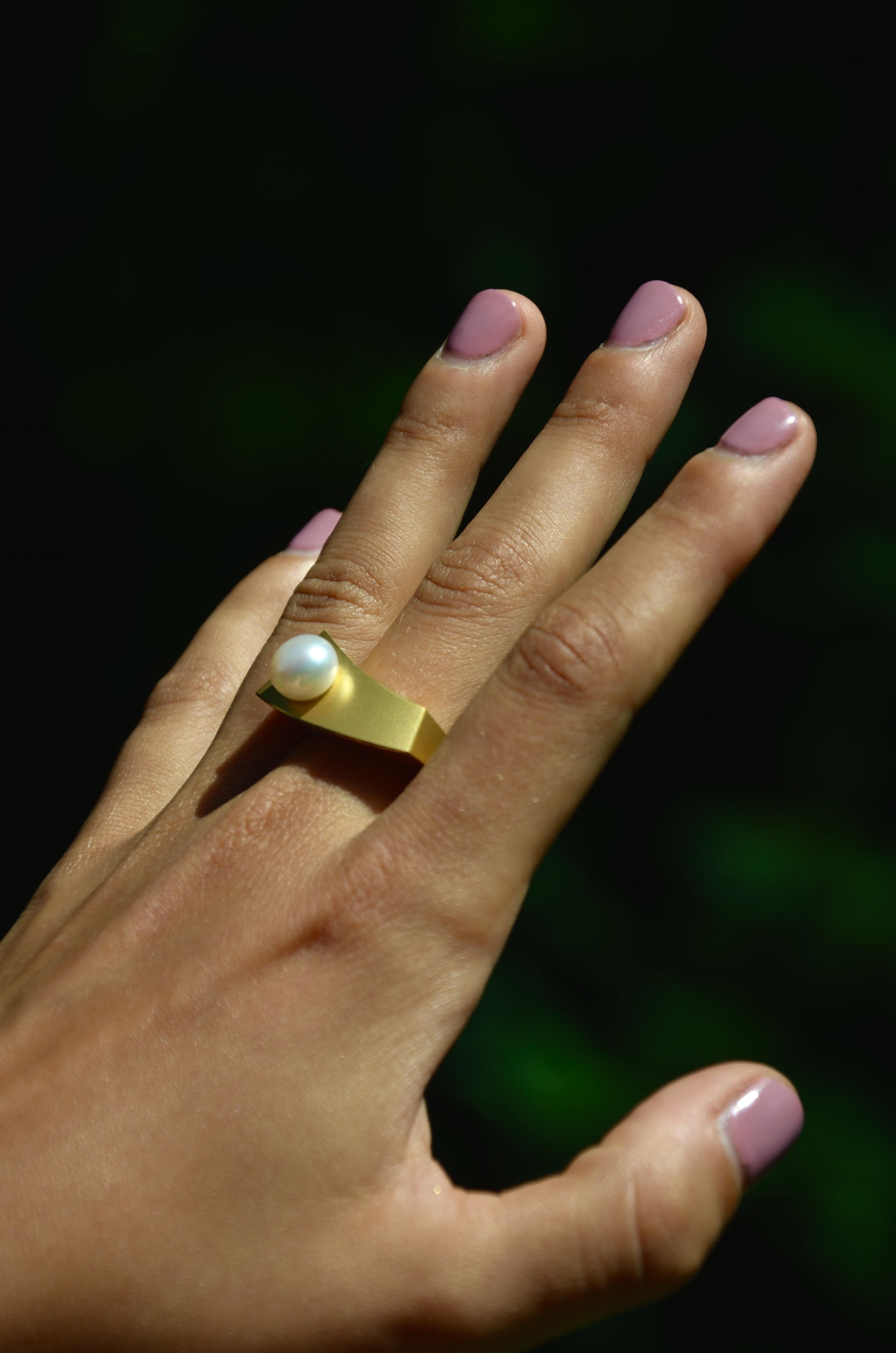 18 Karat Yellow Gold Freshwater Pearl Cocktail Ring

By Arno Schneider, wavey clear structure giving this perfect pearl the stage to shine in her brightest light. Following these lines is like a mediation, calming and exciting, connecting opposing