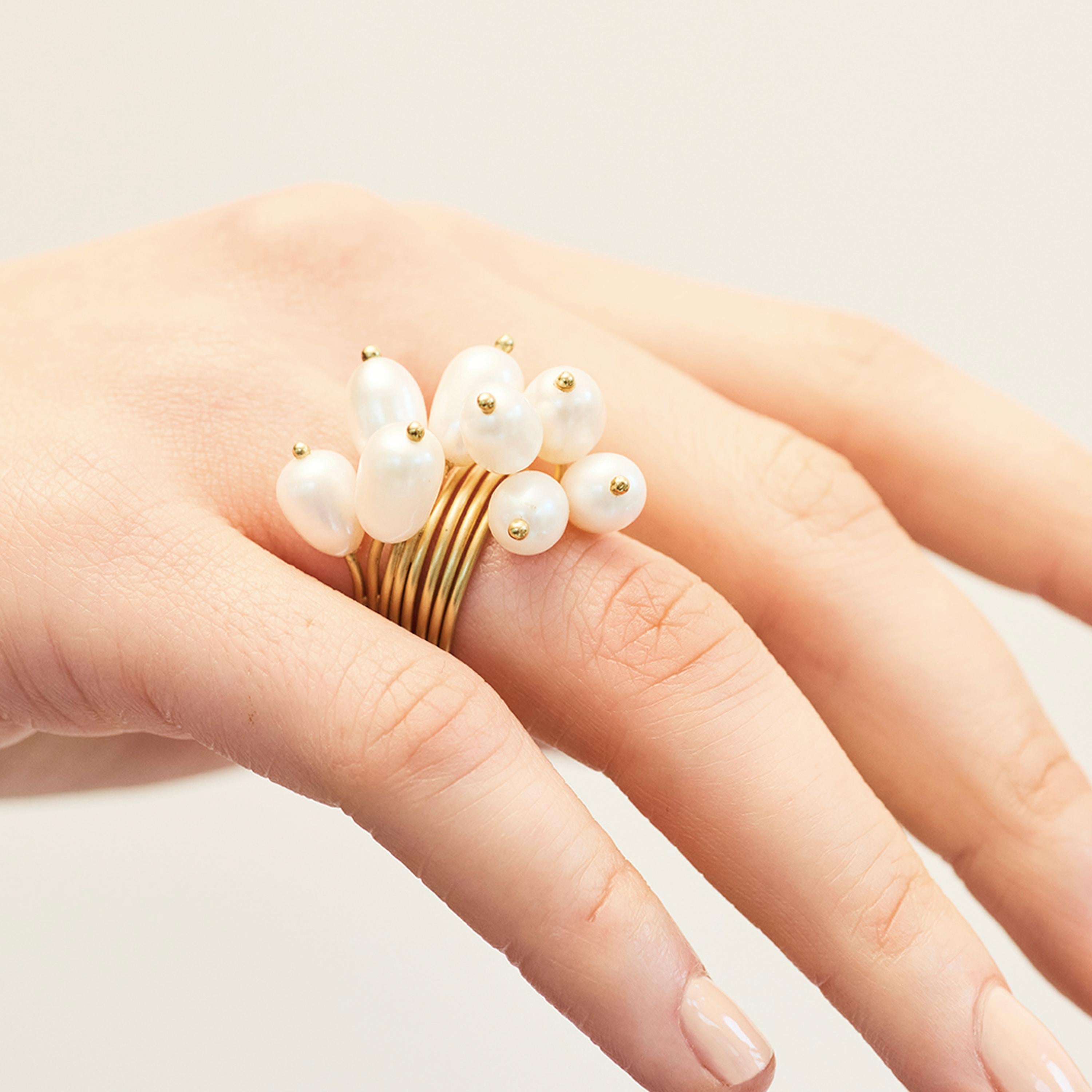 Ambroise Degenève’s Roseaux ring is created using freshwater pearls and Silver 750 (8g). The reeds-shaped pearls are beautifully presented on an elegant wire ring shank made from 18k karat yellow gold. Made to order, this piece takes between 6 and 8