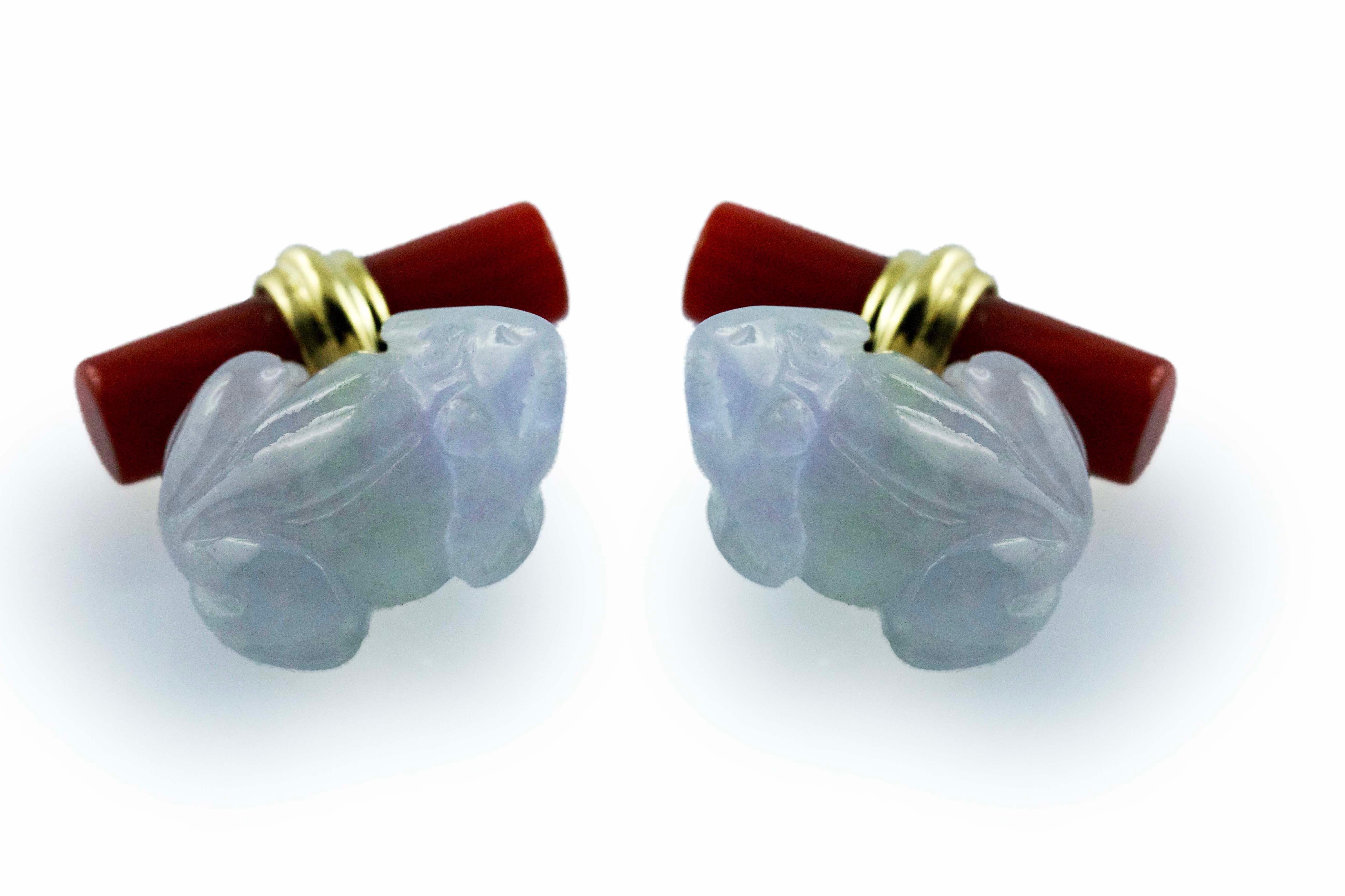This playful pair of cufflinks is made in jade and its front face is carved to depict the body a frog . The natural and particularly lavender violet of this jade emphasize the dark orange of the carnelian of which it is made the back toggle, simple