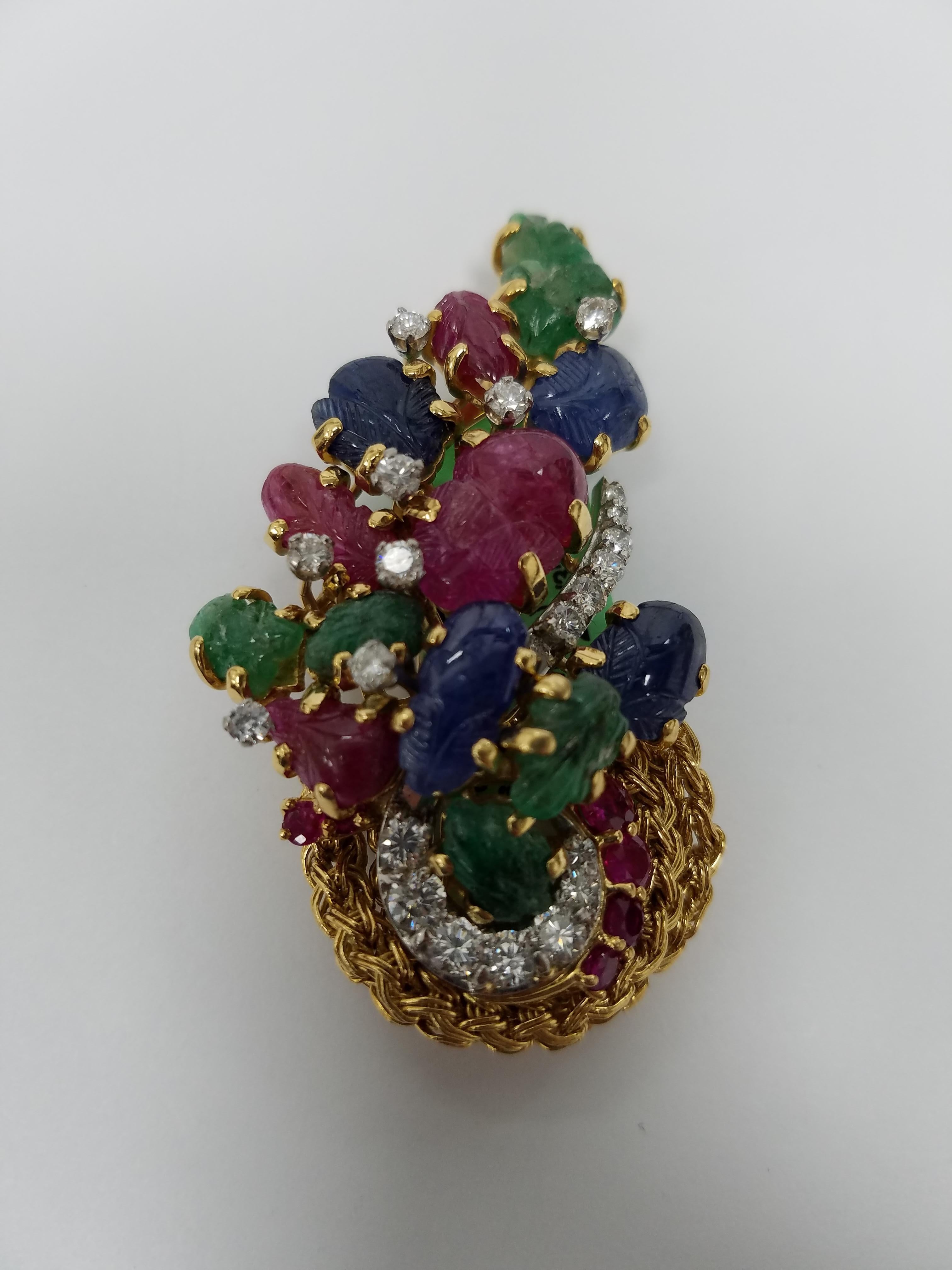 18k Yellow Gold Signed Kutchinsky Brooch with mixed stones. 20 Diamonds aprox 2.25 carats . Also has Emeralds, Sapphires and Ruby. 