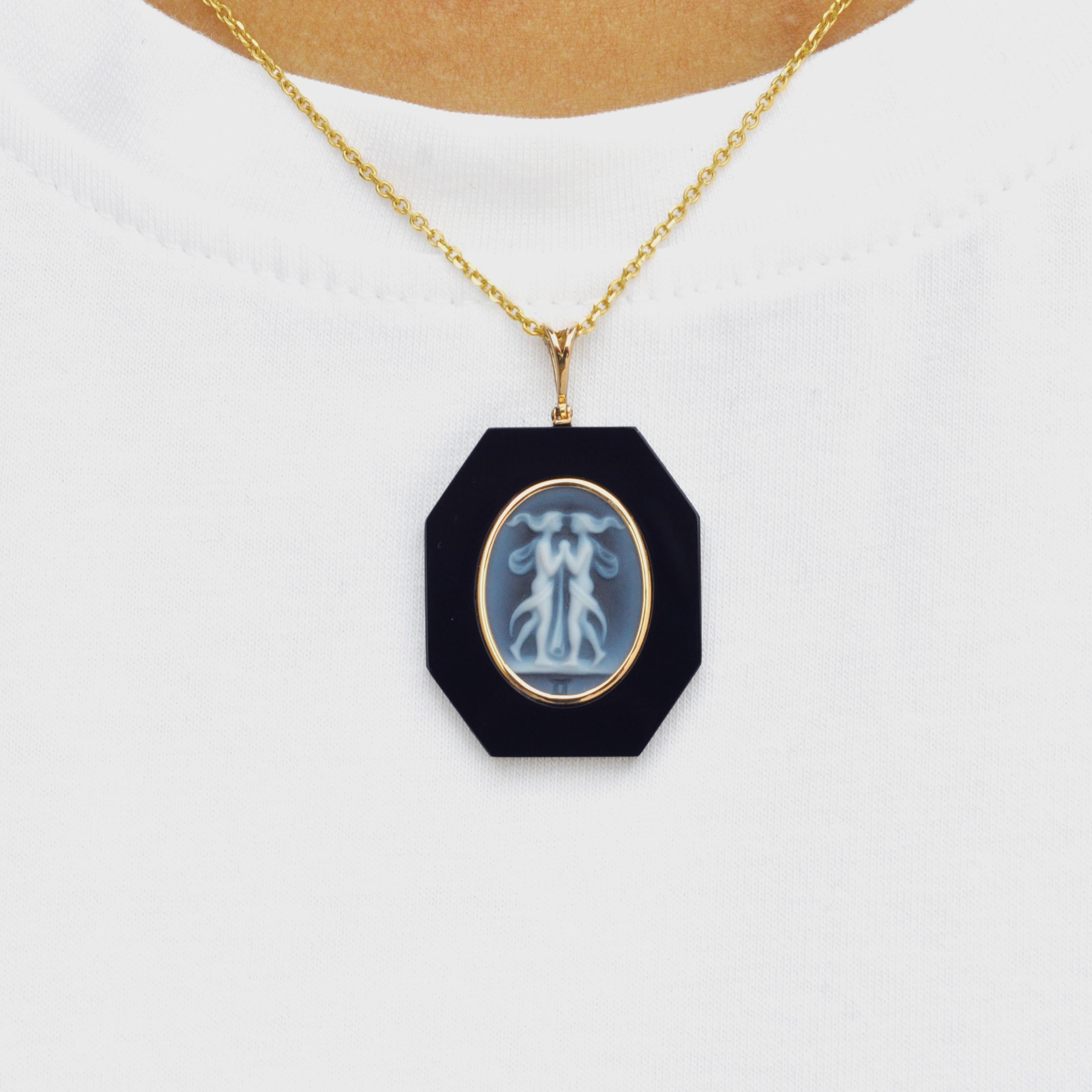 18 karat yellow gold gemini zodiac agate cameo black onyx pendant necklace. 

This exquisite pendant showcases a stunning combination of contemporary design and timeless elegance. Crafted in 18K gold, the piece features a sleek loop from which