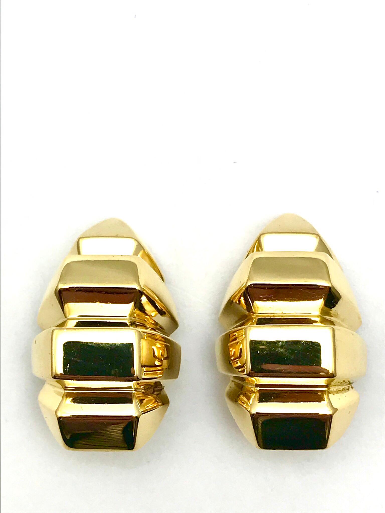 A pair of 18 karat yellow gold geometric shape  clip-on earrings.  Designed in a squared off rib like structure, the earrings feature an omega clip back.  (Posts can be added)

Hallmark:  18K