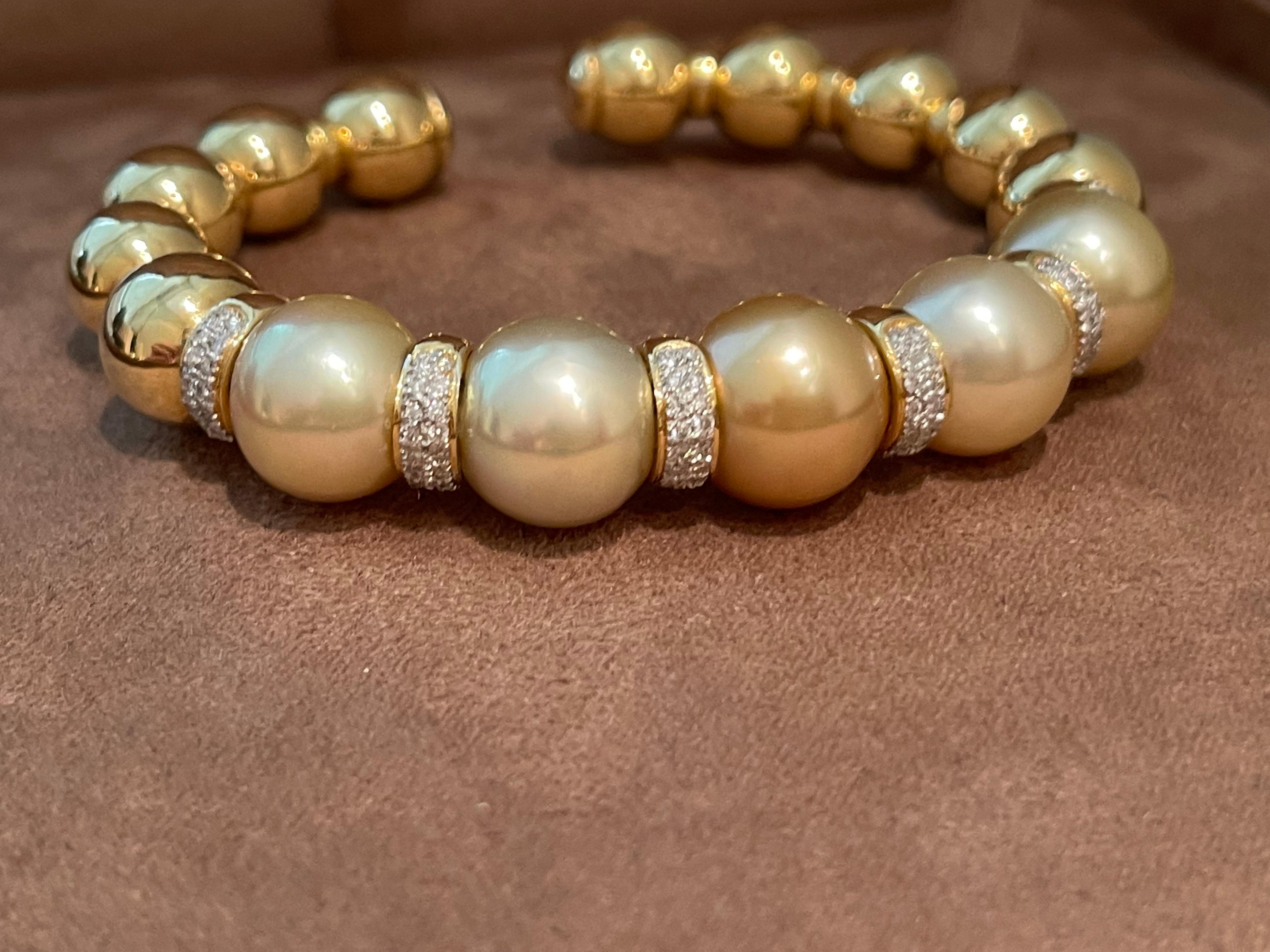 This elegant bracelet is set with 5 golden South Sea Pearls, accented with Diamond rondelles; set in 18-karat yellow gold. Flexible with open back. 96 Diamonds weighing 0.75 ct. South Sea pearls ranging from 12.5 mm- 13 mm. The bracelet measures 6