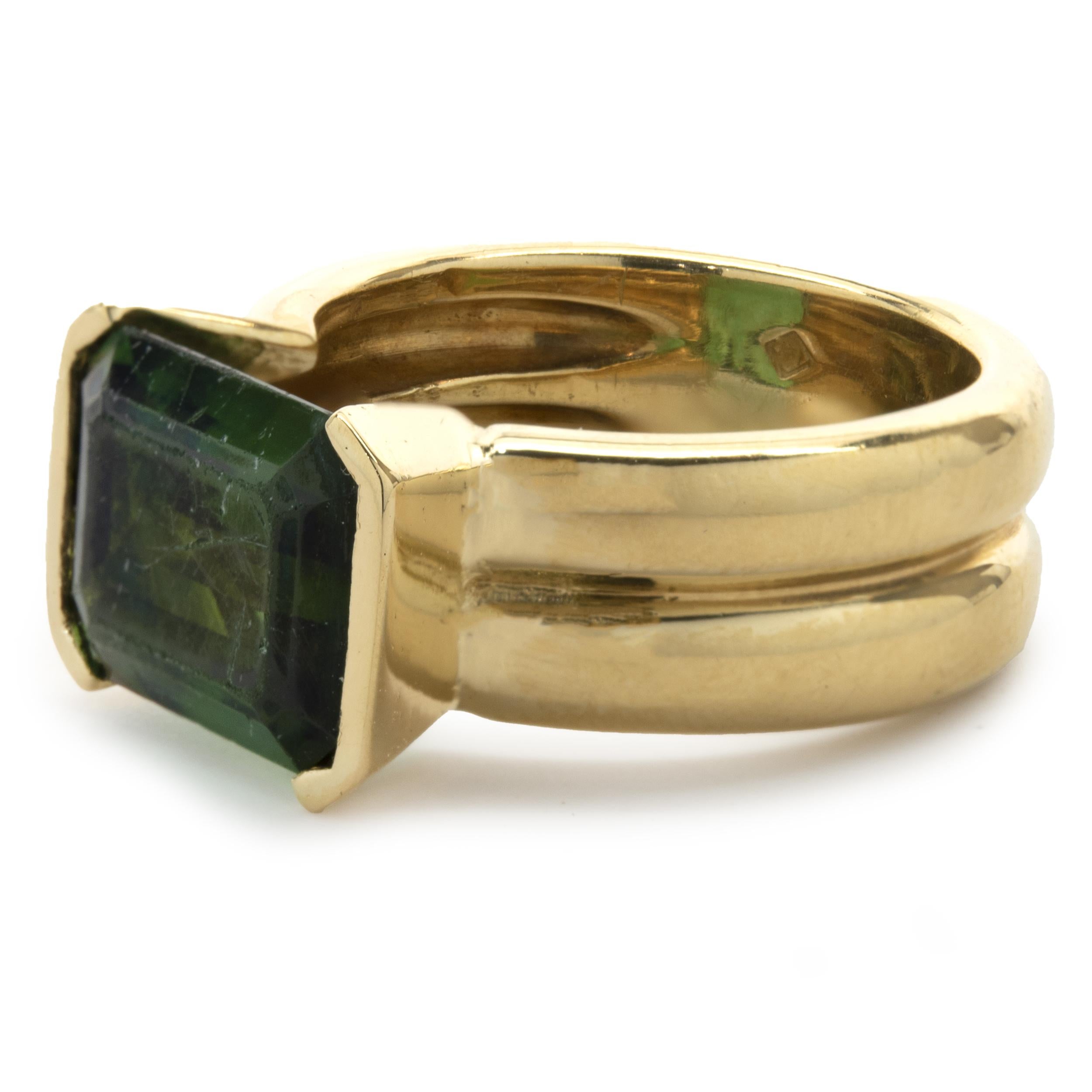 Designer: custom
Material: 18K yellow gold
Green Tourmaline: 1 emerald cut = 4.44ct
Dimensions: ring top measures 10.4mm
Ring Size: 7.5 (complimentary sizing available)
Weight: 12.10 grams
