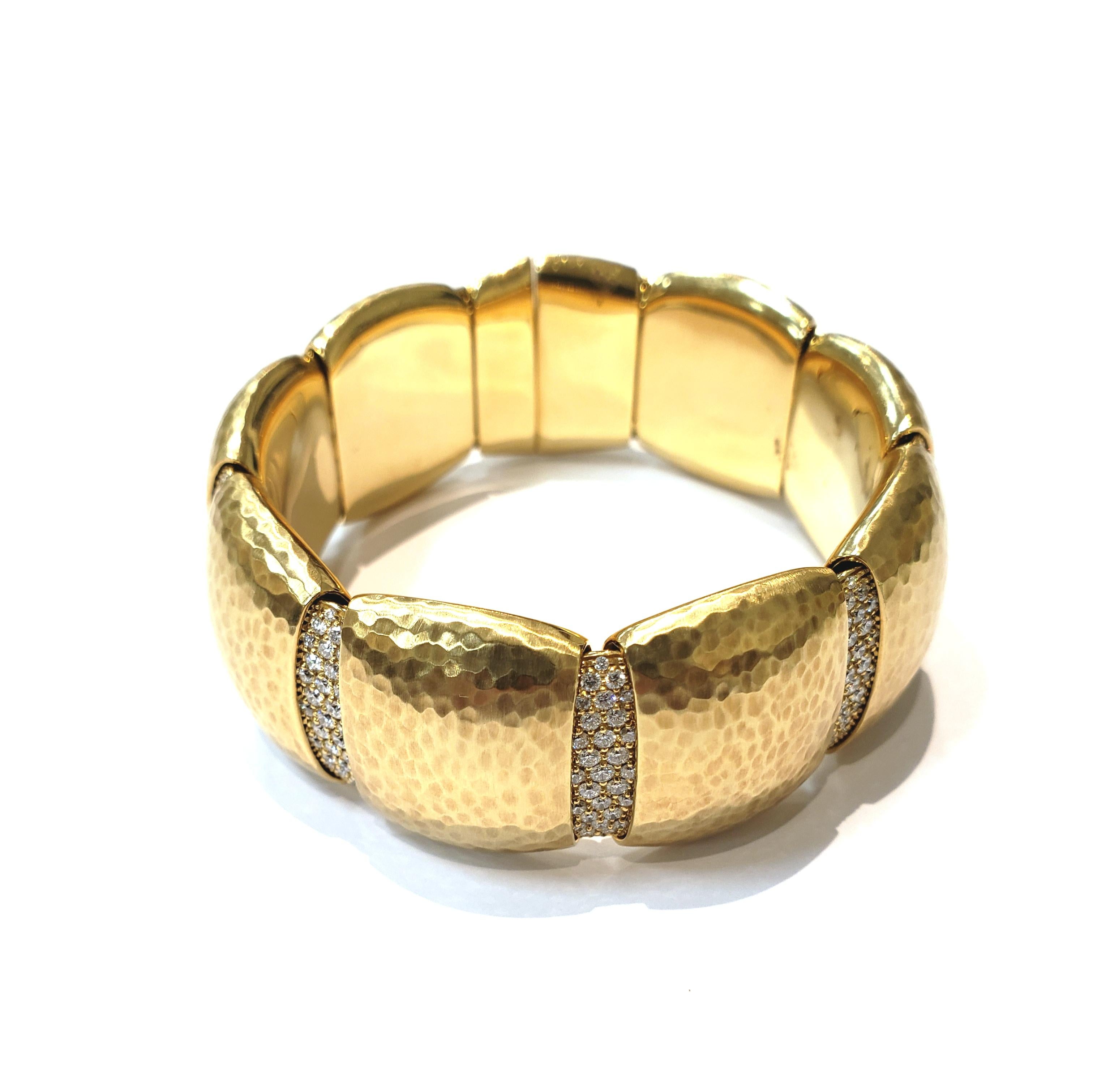 Italian Made 18 Karat Yellow Gold Hammered Bangle with Pave Diamond Stations. Bracelet is Flexible With Tongue Style Clasp.
Between Each Hammered Section Is a Pave Diamond Section. Overall Length is 7.1 Inches. Bracelet Weight is 60.50 DWT.
Bracelet