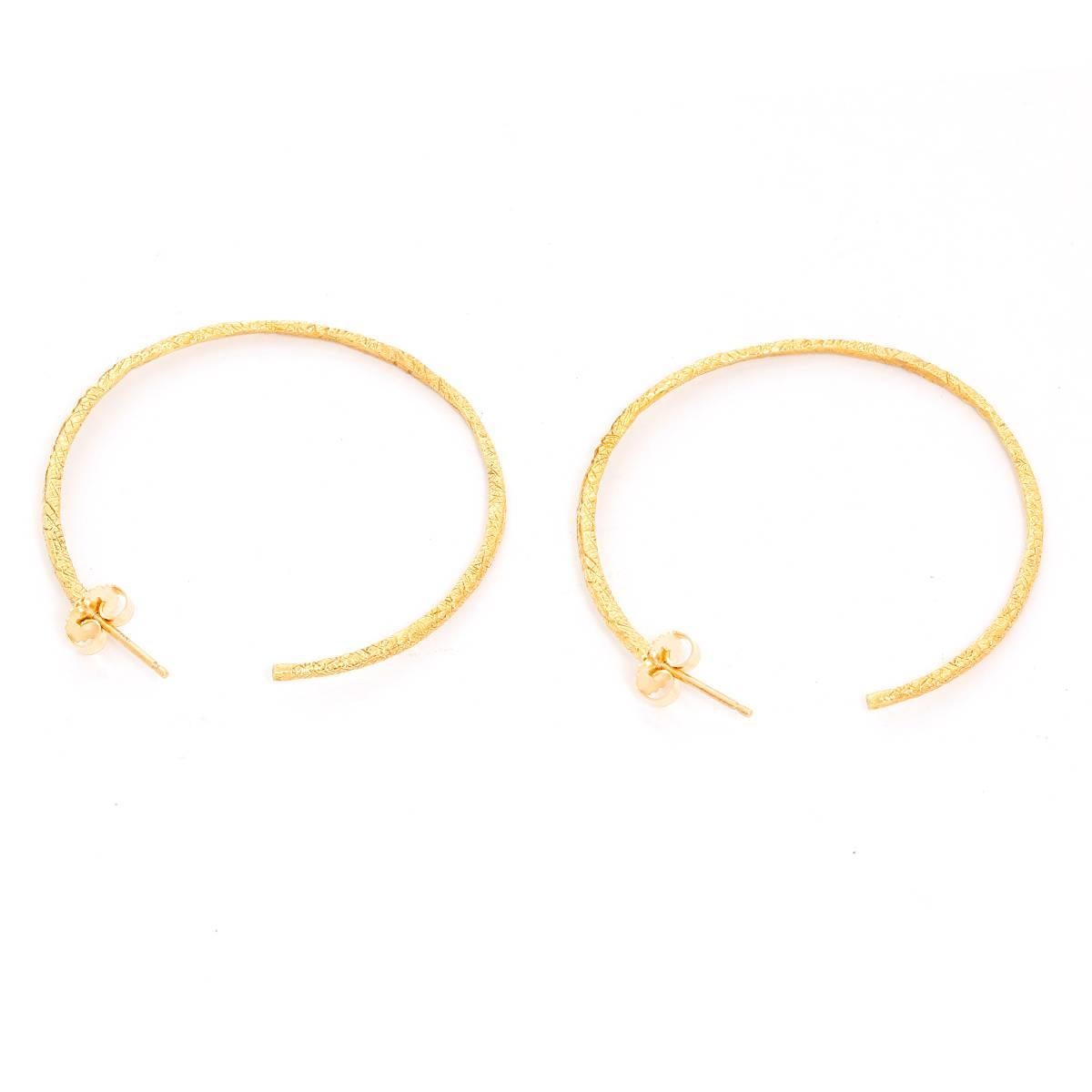 18K Yellow Gold Hammered Earring Hoops - 2 inches in diameter .2 mm in thickness. Total weight of 8.4 grams. Perfect for an every day look.