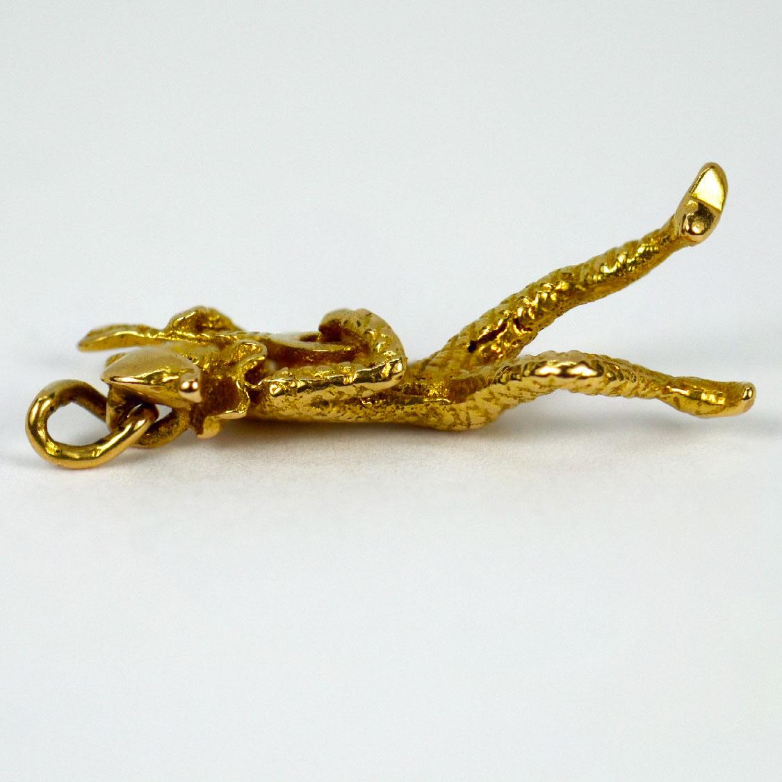 An 18 karat (18K) yellow gold charm pendant designed as a Harlequin figure from the Commedia dell’Arte playing a lute. Stamped with the owl mark for French import and 18 karat gold.

Dimensions: 2.7 x 0.8 x 0.8 cm (not including jump ring)
Weight: