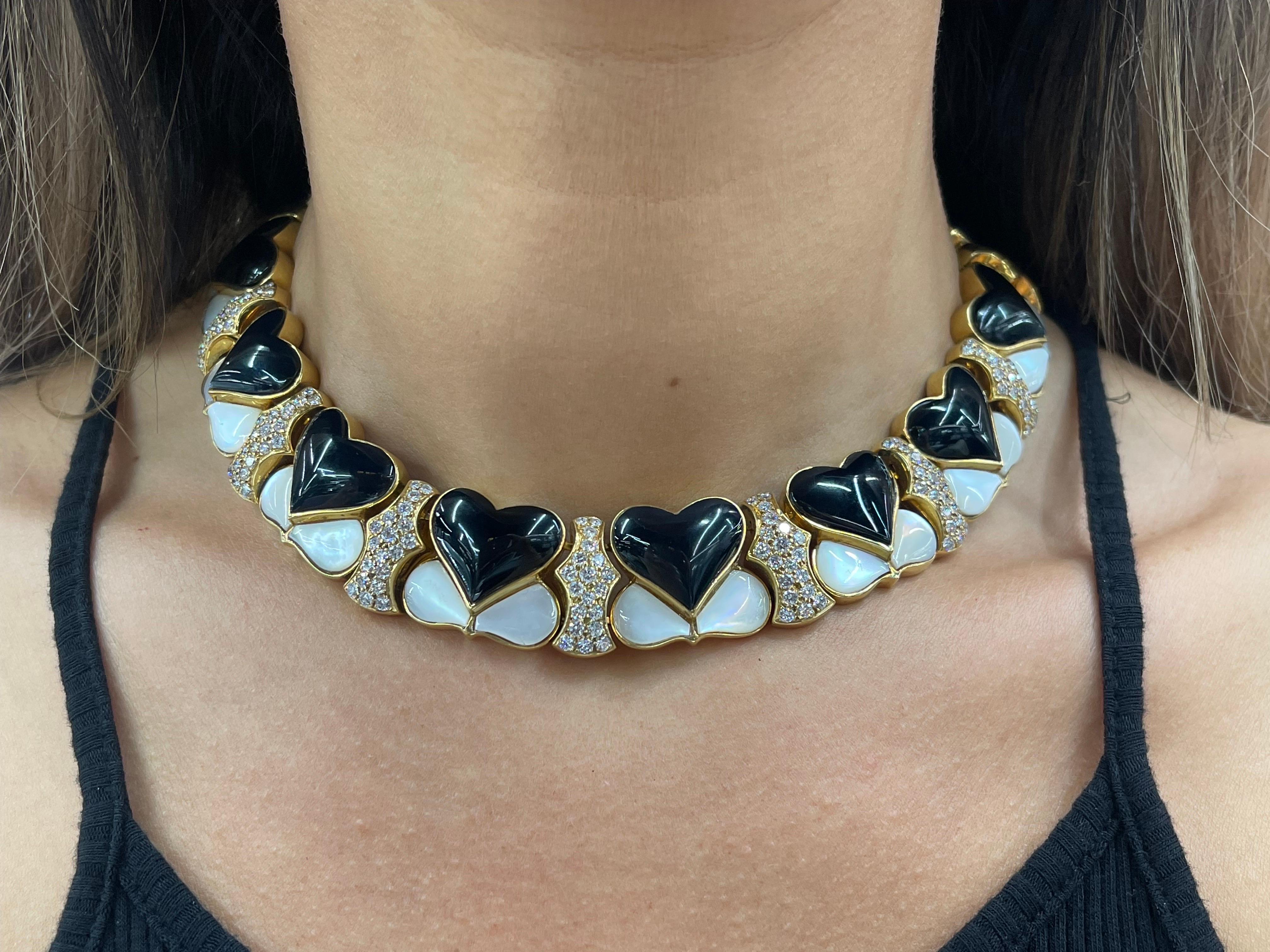 18 Karat Yellow Gold wide collar necklace featuring Onyx Hearts, decorative Moonstones and 133 round brilliants weighing approximately 6 carats.
A great conversation piece! 