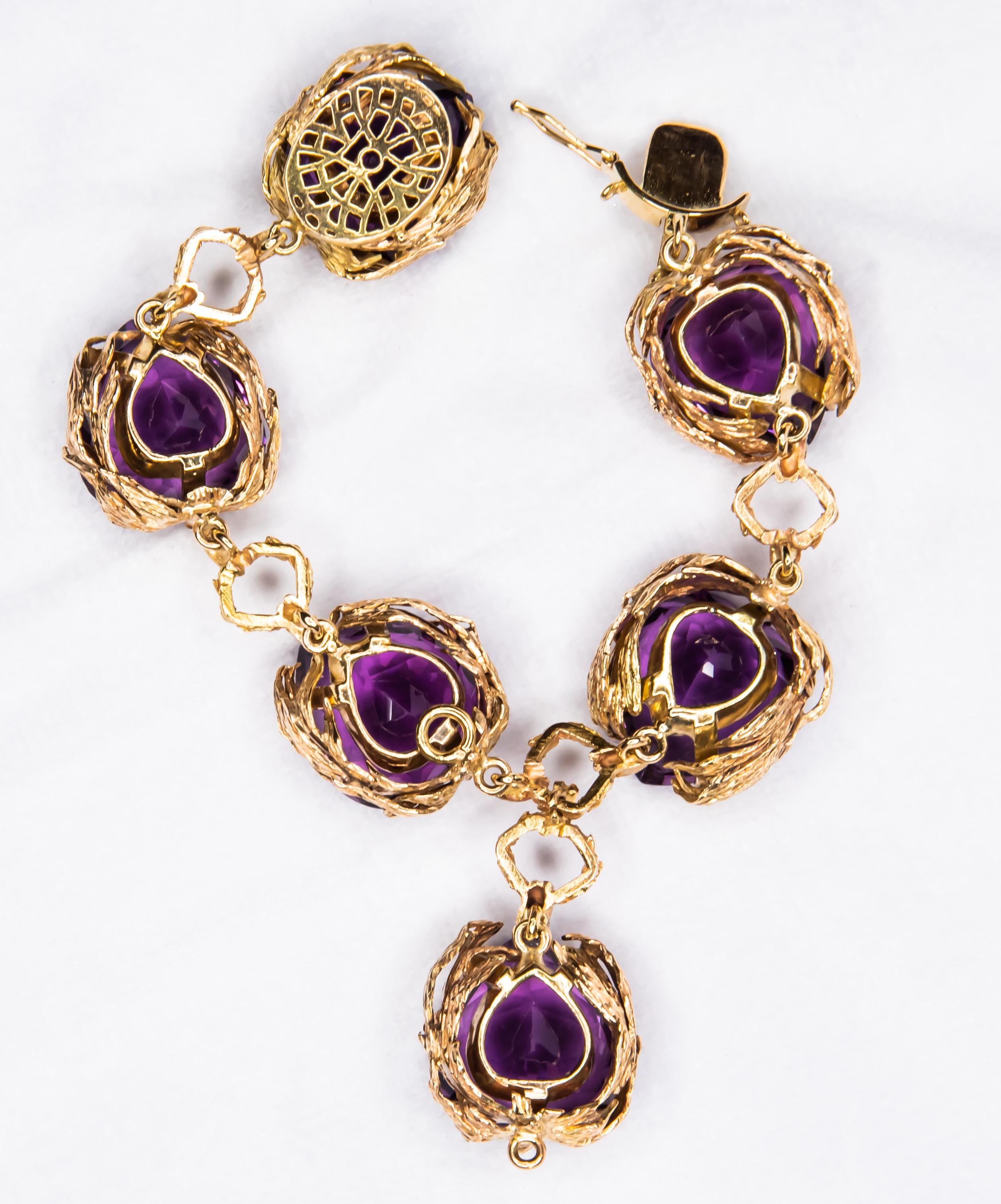 Artfully detailed bracelet crafted in 18 karat yellow gold.  Features 6 perfectly matched Amethysts in heart shapes.  Bracelet was shortened leaving 1 Amethyst section dangling at the center.  It can easily be added back for length if needed.  All 6