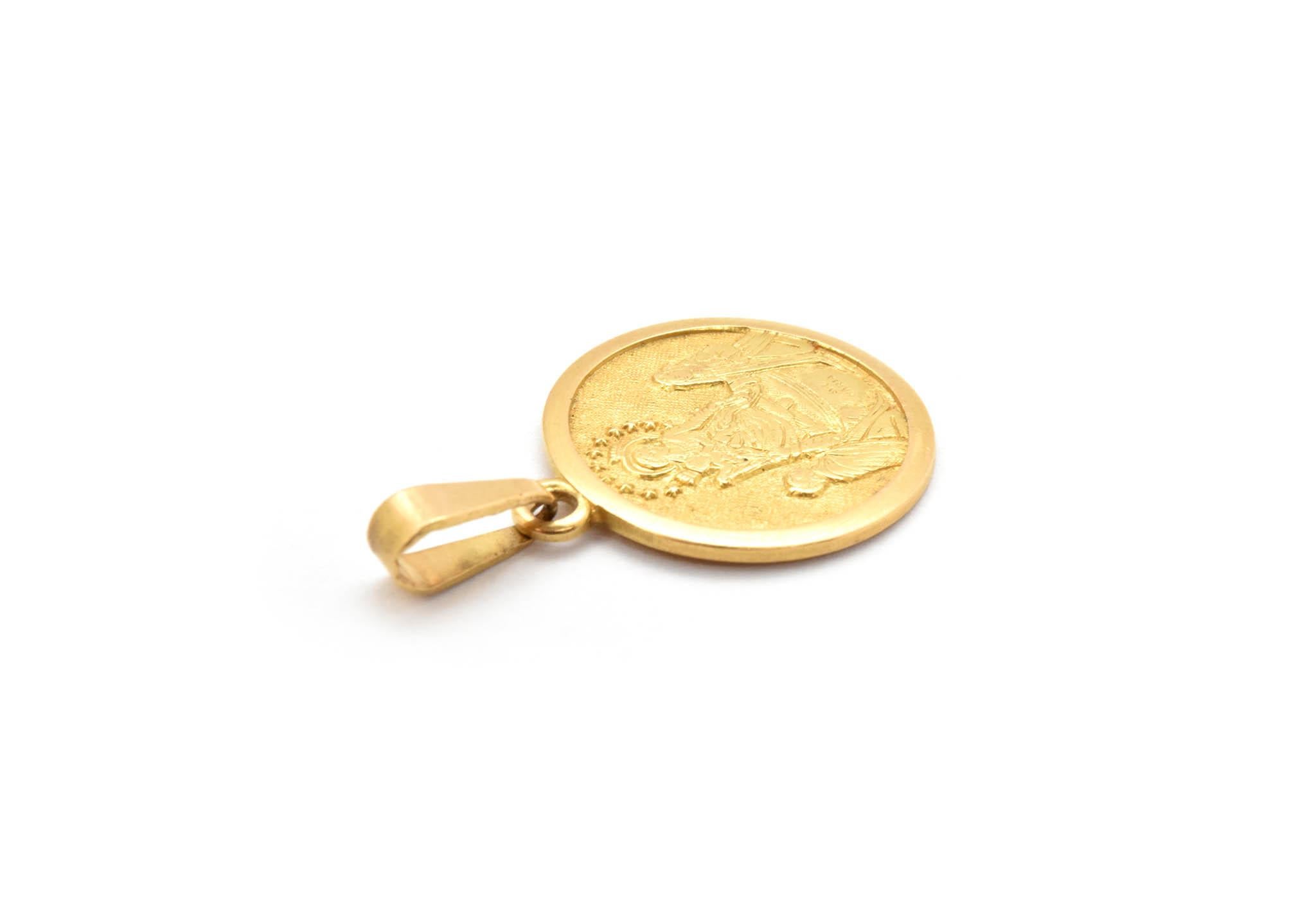 This religious medal pendant is made in solid 18k yellow gold. This pendant is round and depicts the Holy Family Nativity scene. The pendant weighs 3.65 grams. The pendant measures 18mm in diameter.