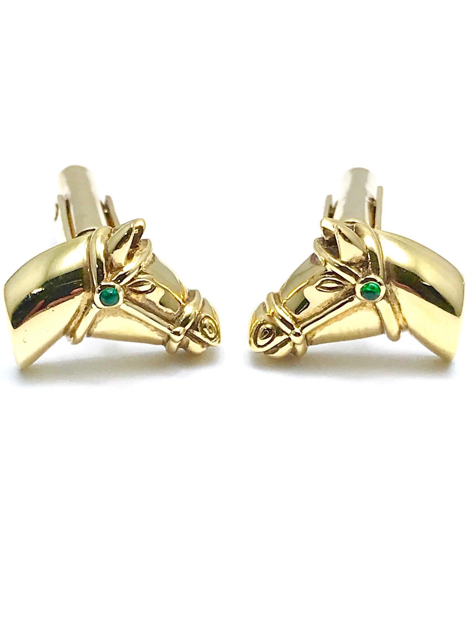 The perfect cufflinks for any horse enthusiast!  These are made in 18 karat yellow gold, with a cabochon emerald on the horse's bridle.  The horse's face shows great detail.  The cufflinks have a simple toggle back for ease of use.  The horse head