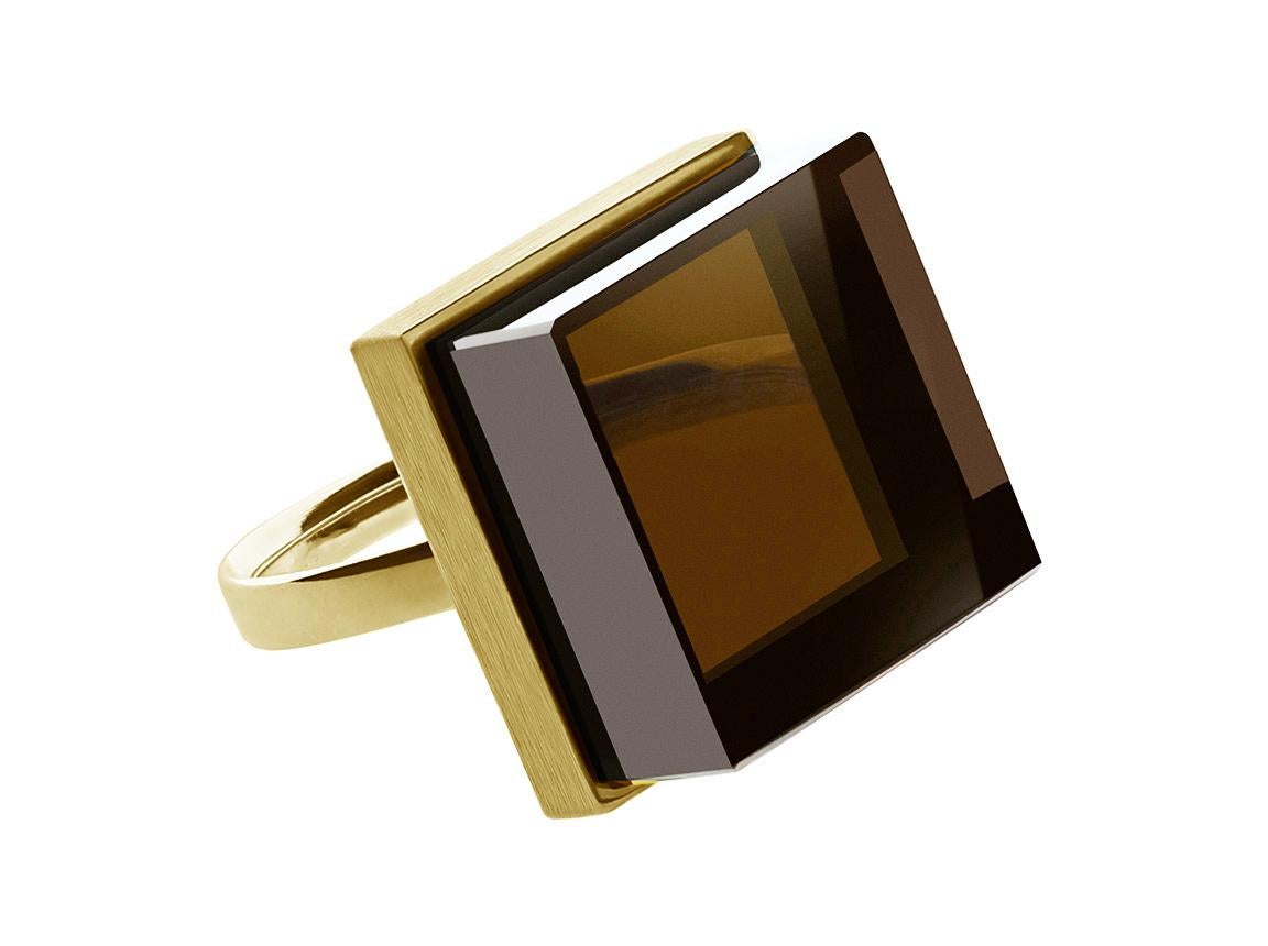 This contemporary ring is crafted from 18 karat yellow gold and features a 15x15x8 mm natural smoky quartz. It has been featured in both Harper's Bazaar and Vogue UA.

The ring's design reflects the Art Deco style and can be worn by both men and