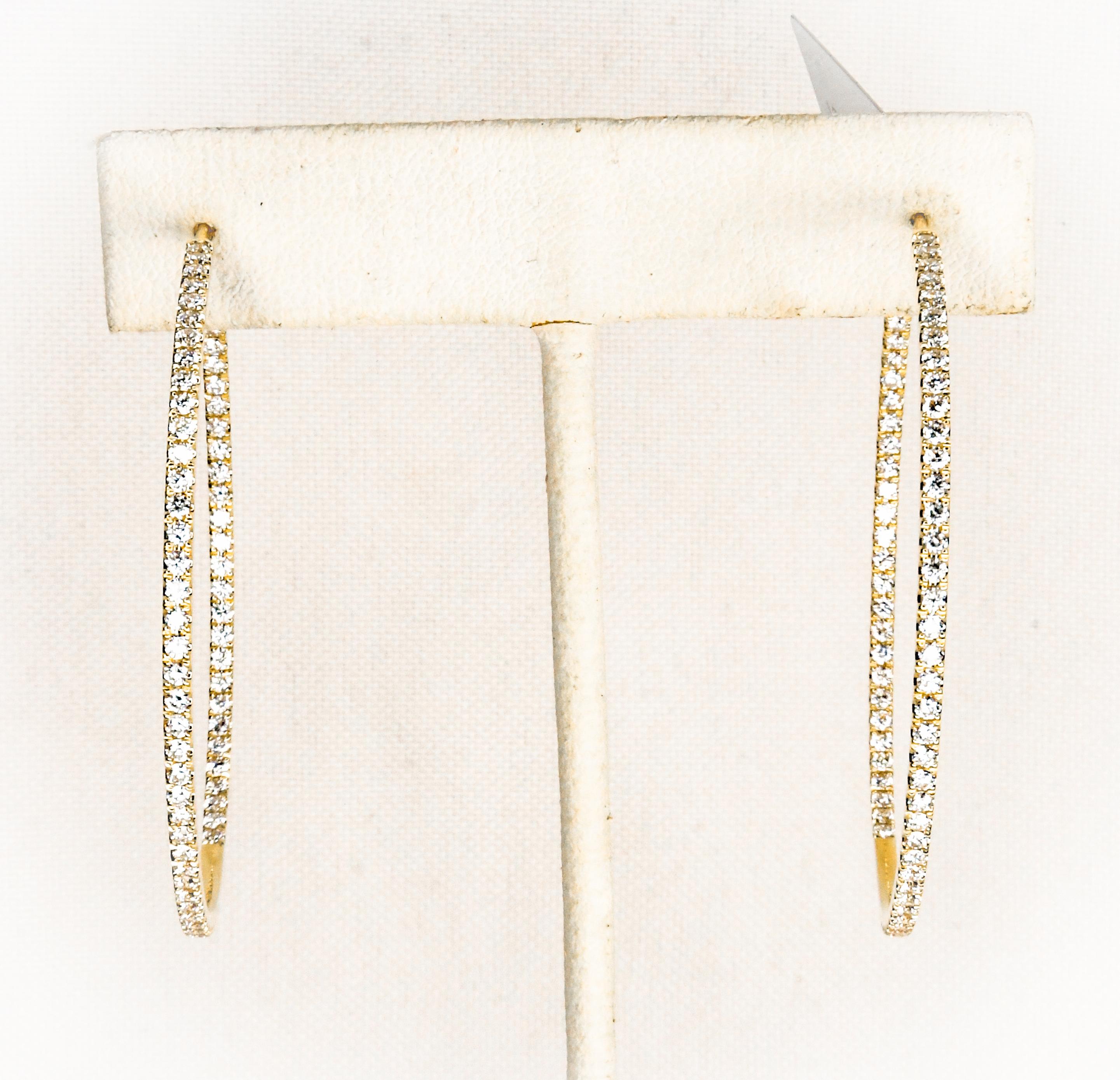 Oh, the classic and never out of style hoop earring!  Fabricated in 18 karat yellow gold there are brilliant cut pave diamonds facing forward both on the outside and inside.  Brilliance is amazing!  Hinged pierced backs make on and off a breeze! 