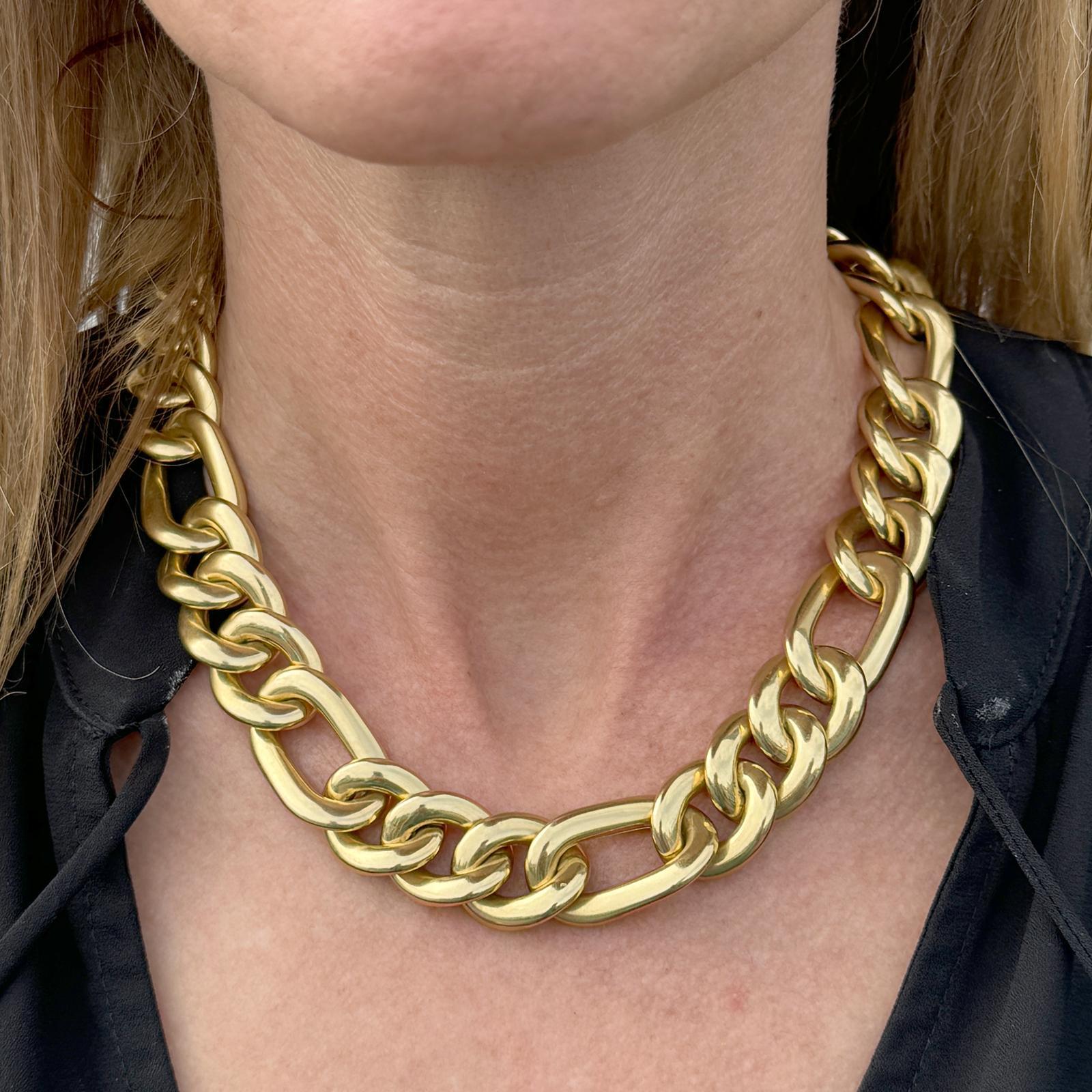 Heavy Italian figaro link necklace crafted in 18 karat yellow gold. The necklace measures 17 inches in length, approximately 18mm in width, and features a large lobster clasp. Weight: 99.5 grams.