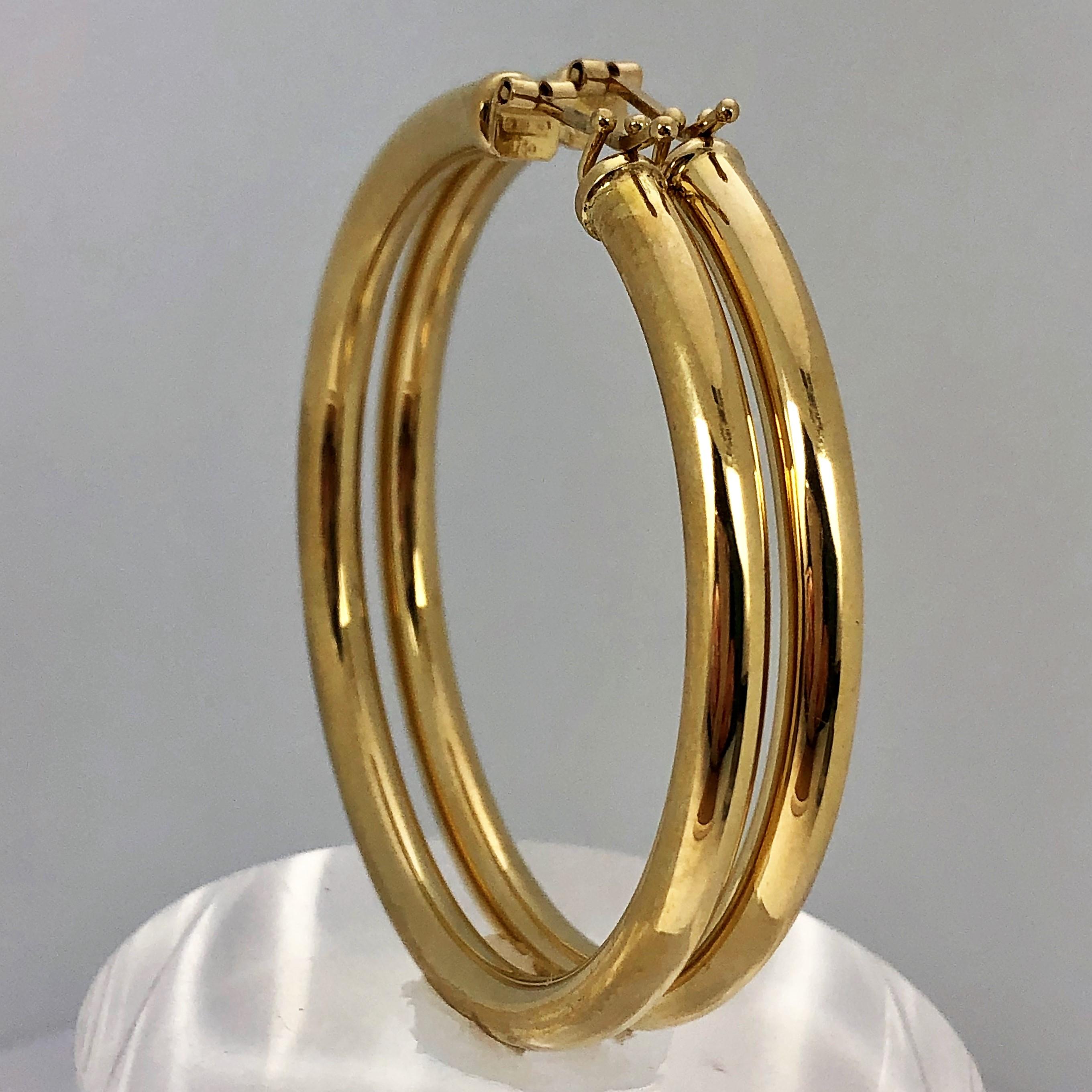 Made in Arezzo, Italy, these wonderful 2 1/16 inch diameter 18K Yellow Gold Hoops are a 
staple in any woman's jewelry collection. Easy to wear and lightweight, but not flimsy, like 
many of today's newly manufactured hoop earrings. Measuring 2 1/16