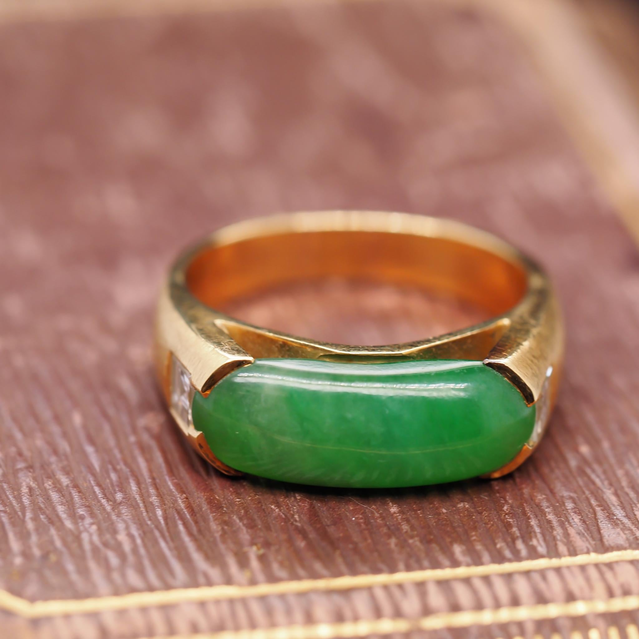 Ring Size: 10.5
Metal Type: 18K Yellow Gold  [Hallmarked, and Tested]
Weight:  12.3 grams

Diamond Details: .80ct, total weight. Natural Diamonds, Carre Cut, E Color, VS Clarity

Center Stone Details: Jade, Oval Cabochon, Natural Green. Measures