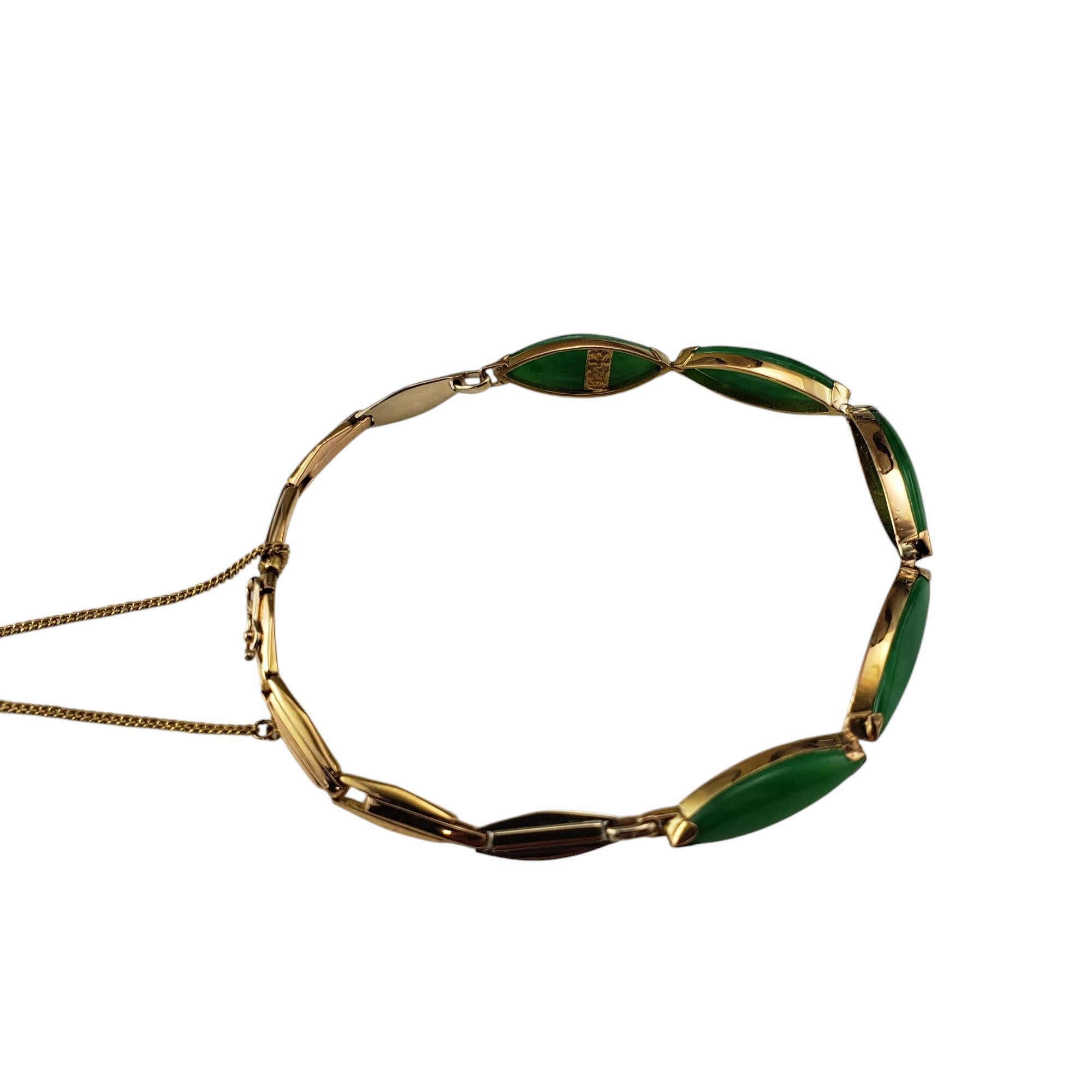 18 Karat Yellow Gold Jadeite Link Bracelet -

This elegant bracelet features five marquise shaped cabochon jadeite stones set in classic 18K yellow gold. Width: 7 mm.

Approximate total jadeite weight: 9.76 ct.

Size: 7.25 inches

Weight: 6.6 dwt./