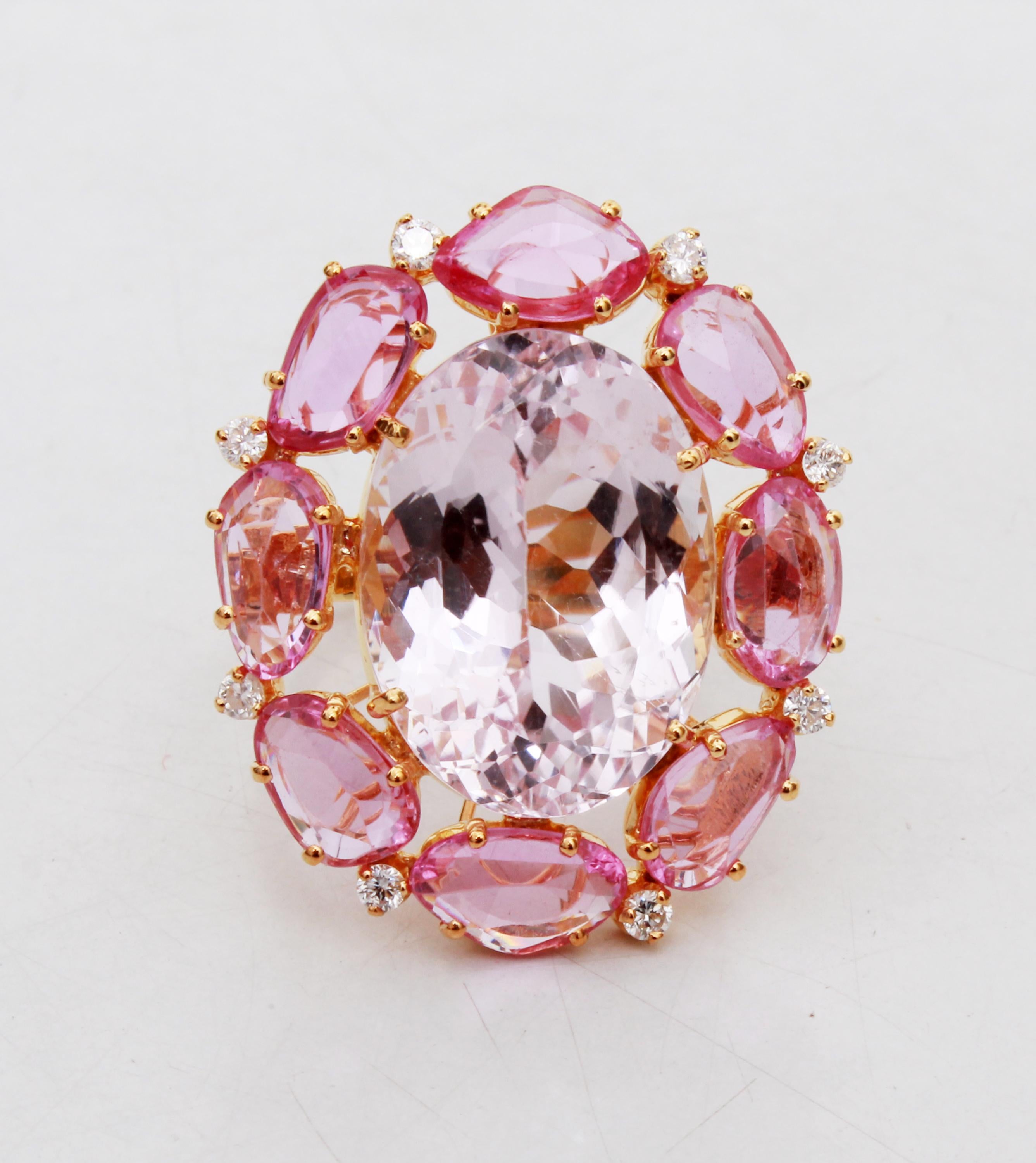 This beautiful ring has a 16.50 carat Kunzite that is set in the center of the ring and with that 8 Rose Cut Pink Sapphires that weigh 6.38 carat. This ring also has 18 Round Cut Diamonds that weigh 0.48 carat and are set along the shank of the