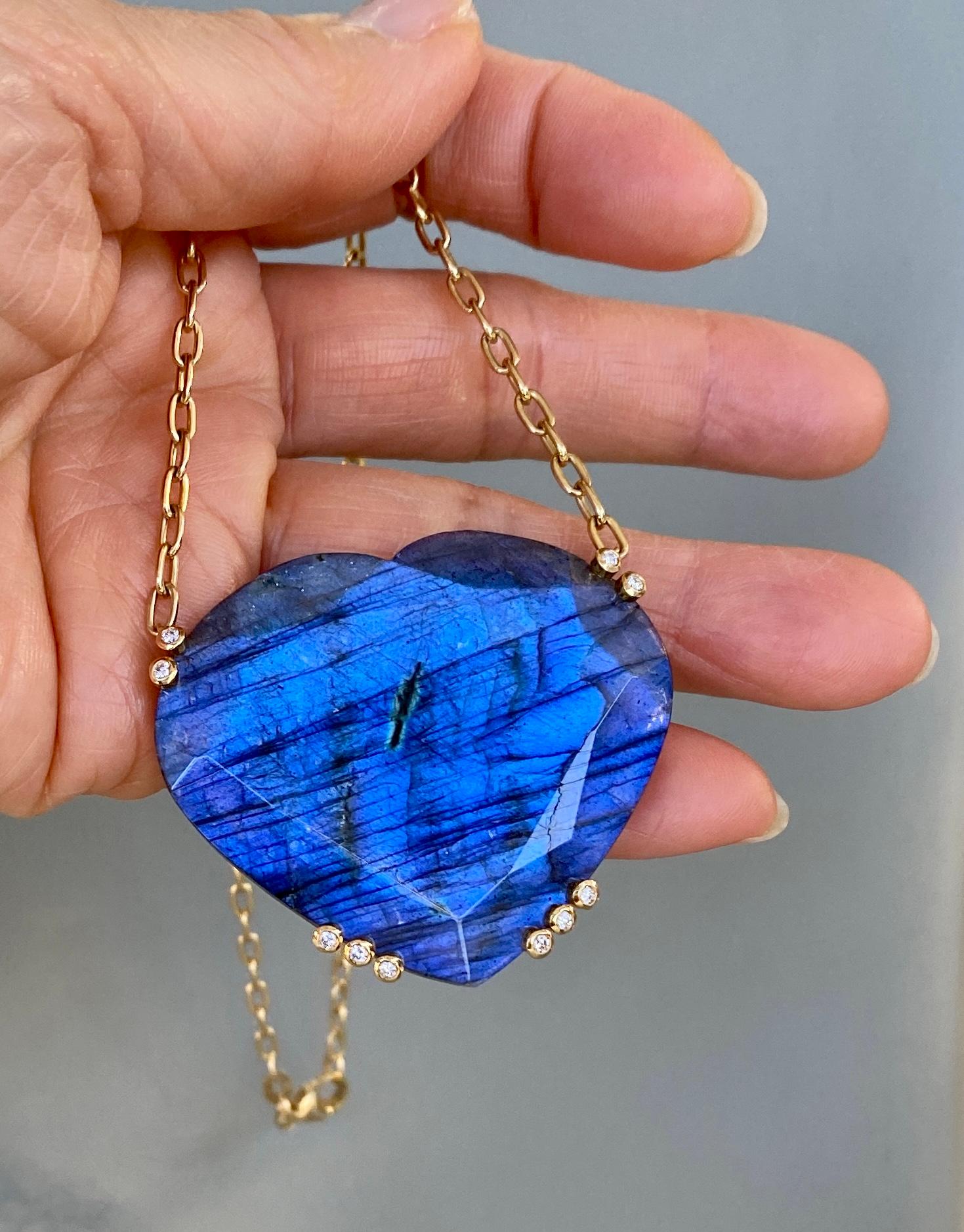 A one-of-a-kind large heart shaped labradorite and diamond pendant necklace, It is handcrafted in 18 karat yellow gold and hangs on a 16 inch gold chain of 14 karats.

This stunning large heart shaped labradorite pendant necklace has perfectly