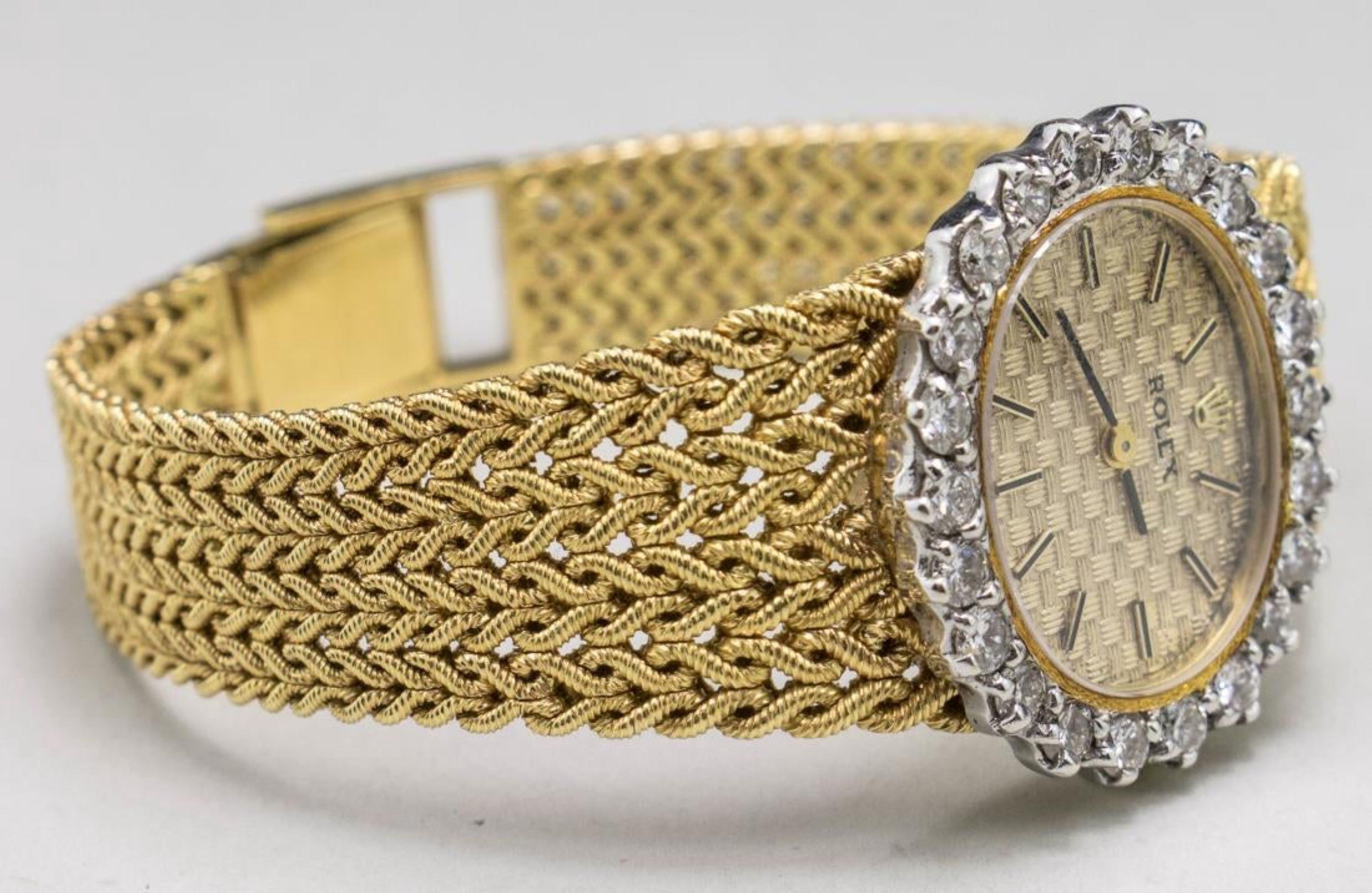 18k yellow gold watch, woven gold watch face with baton hours, signed, diamond bezel and 18k yellow gold bracelet.  Length 7 inches.