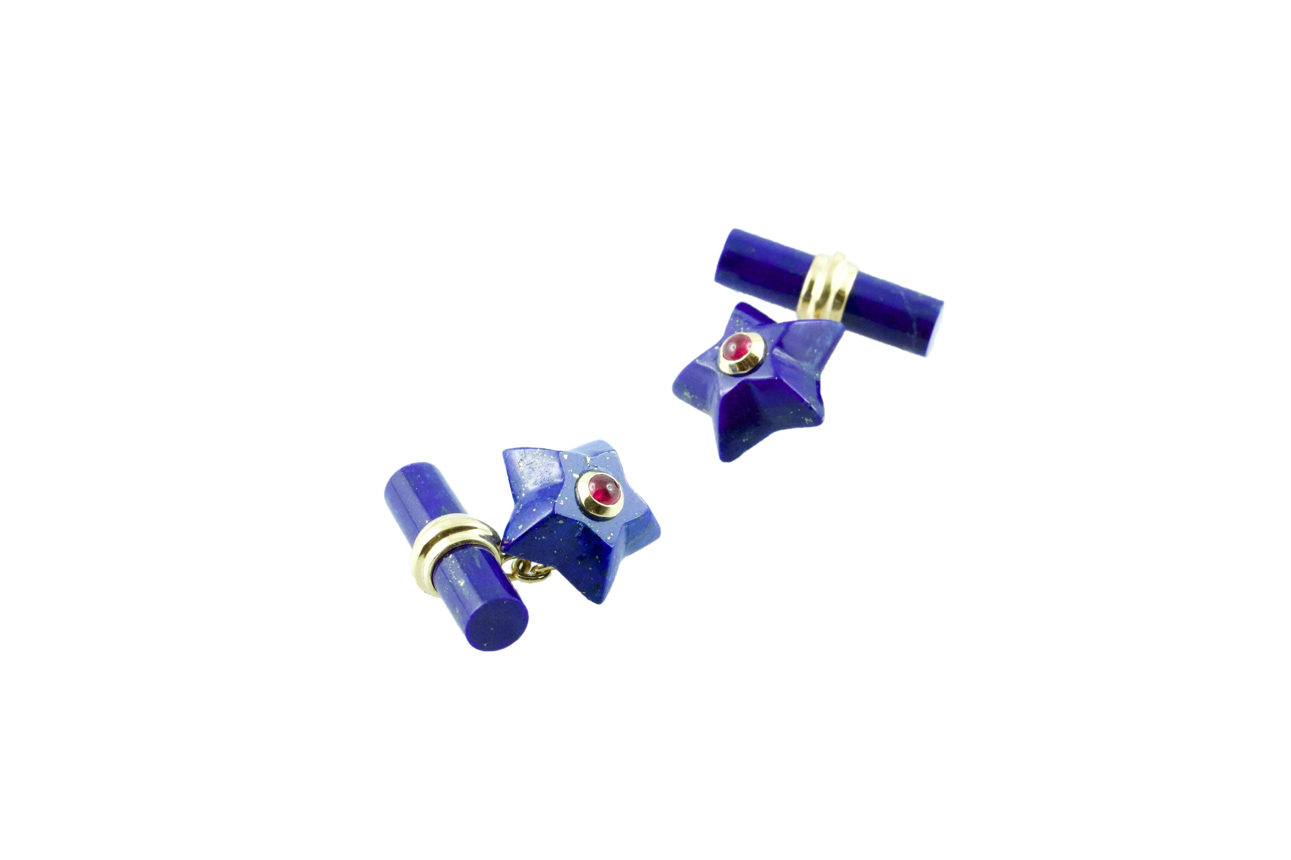 This charming pair of cufflinks is entirely made in lapis lazuli, shaped as stars and adorned in the center with cabochon rubies. 
The 18 karat yellow gold post links this element to the toggle, which is a simple cylinder.

Dimensions:  
           