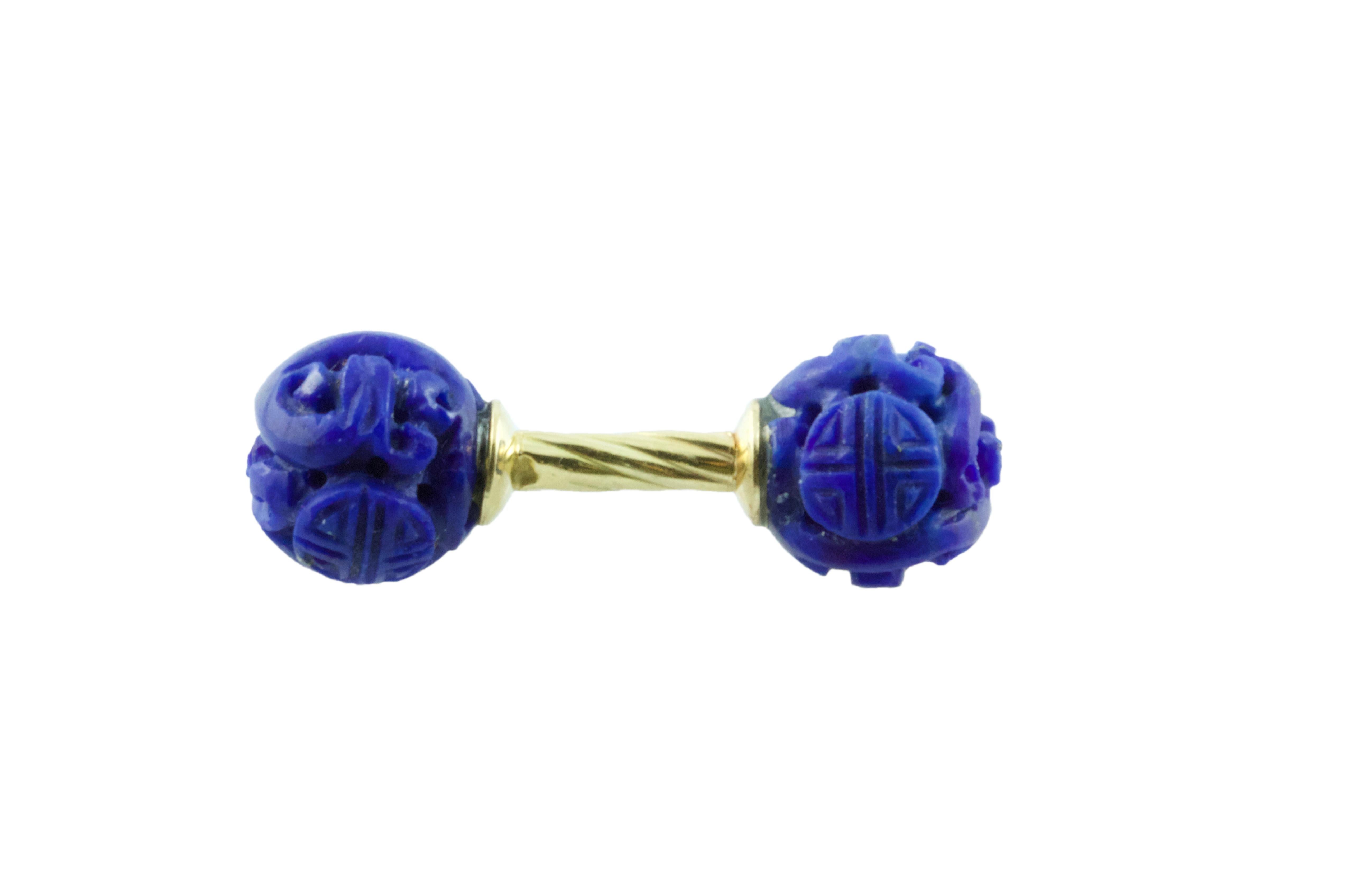 Simple and timeless, these cufflinks are a classic addition to any attire. Their front face and toggle are identical and are carved in a spherical shape out of lapis lazuli, whose dark blue shade strikingly complements the 18k yellow gold of the
