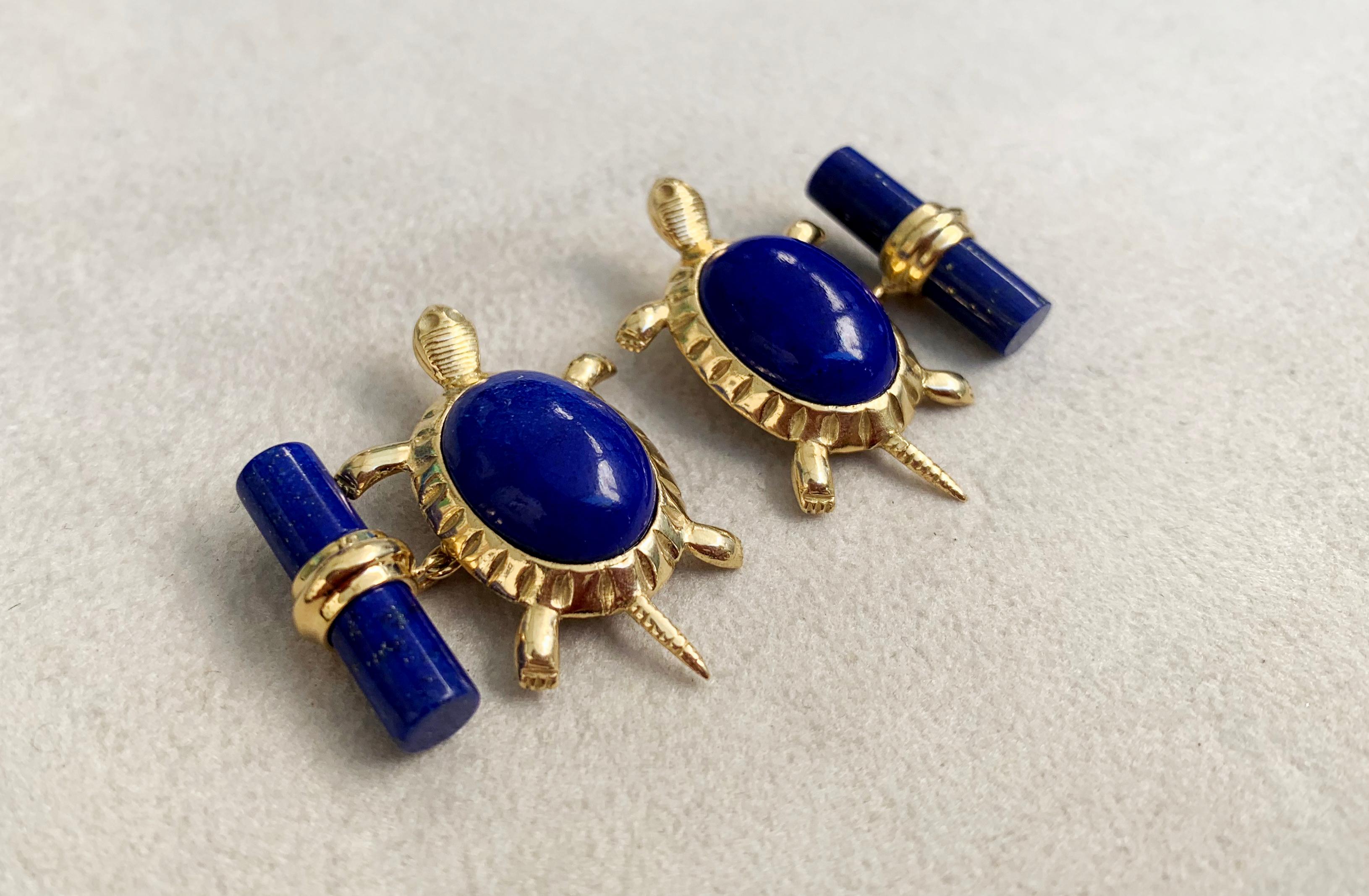 These unique cufflinks combine the deep blue of lapis lazuli with the warmth of 18 karat yellow gold. 
The precious metal is used to make the post and mounting of the front face in the shape of the legs and tail of a turtle, while the cylindrical
