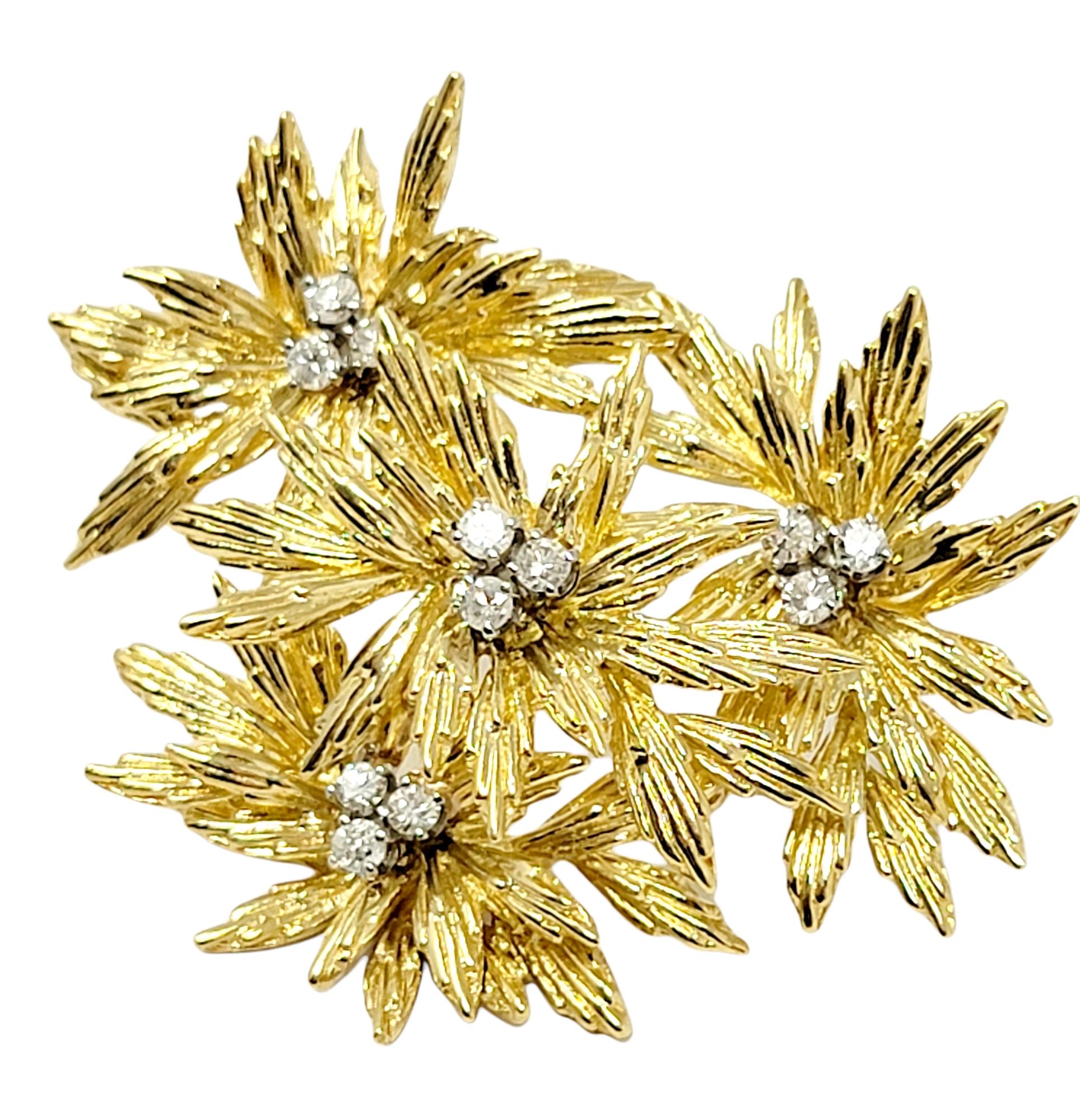 Absolutely stunning diamond and 18 karat yellow gold flower motif brooch. This beautifully detailed piece is accented by incredible sparkling diamonds that shimmer throughout. The exquisite brooch features multiple layers of textured gold petals,