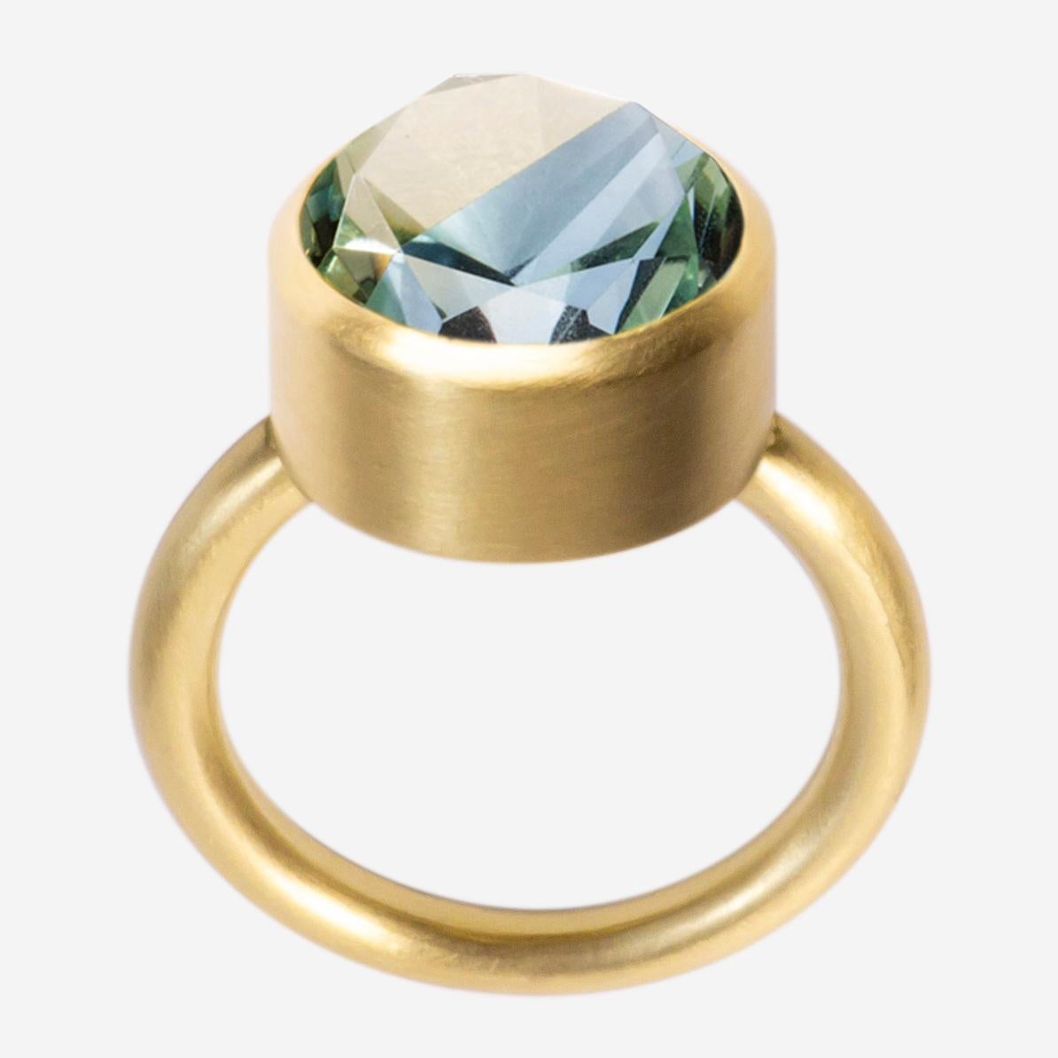 This bold and minimal statement ring is a modern take on the cocktail ring. It features a stone that is fashioned from two natural colored stones that have been fused together then cut and polished as one. When the two characteristics of the