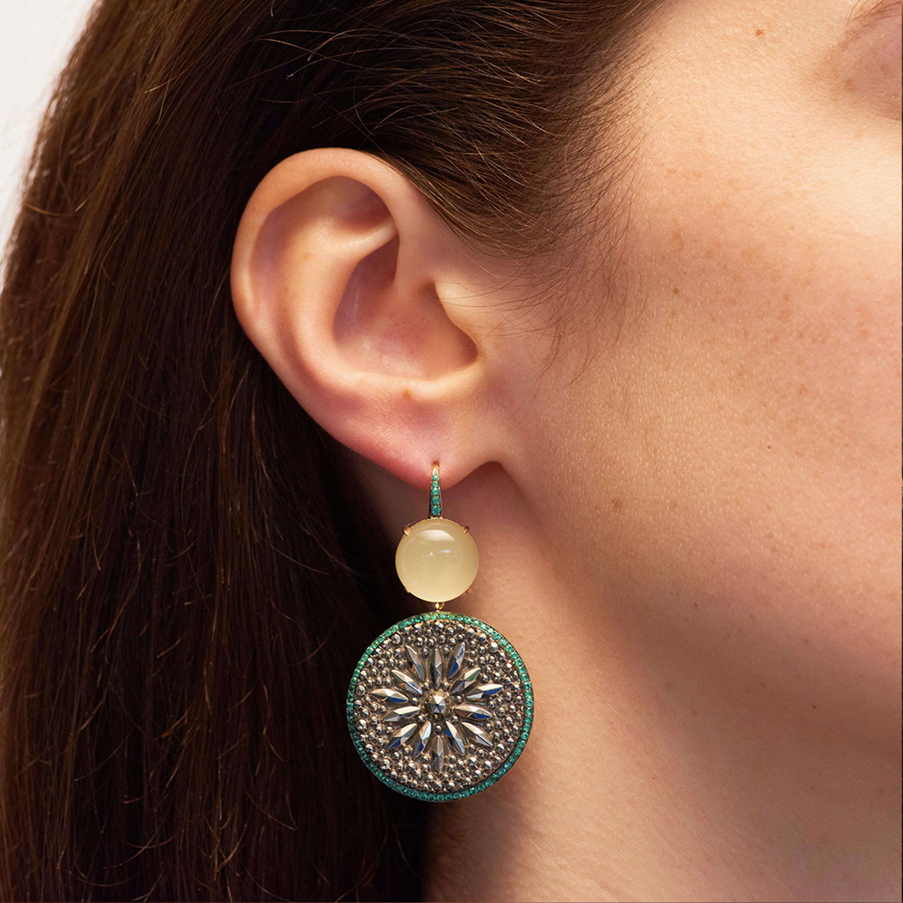 Set in 18 karat yellow gold (27.90g), Francesca Villa's one-of-a-kind earrings are decorated with emeralds (1.0ct) and milky lemon quartz cabochons (17.05cts). Francesca Villa's creation combines two vintage buttons of different origins. A black
