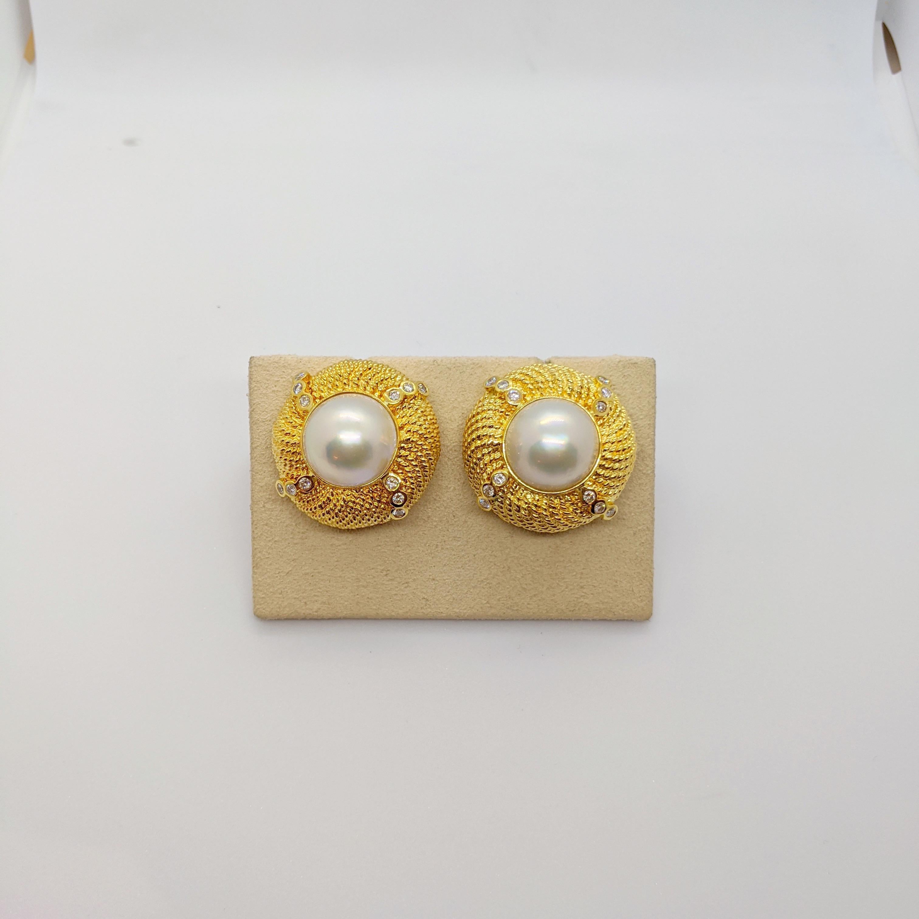 These lovely 18 karat yellow gold earrings have a mabe pearl center. Twelve bezel set diamonds beautifully enhance the round gold button. These earring have a post back with a french clip and can accommodate  pierced and non pierced wearers. 
Total