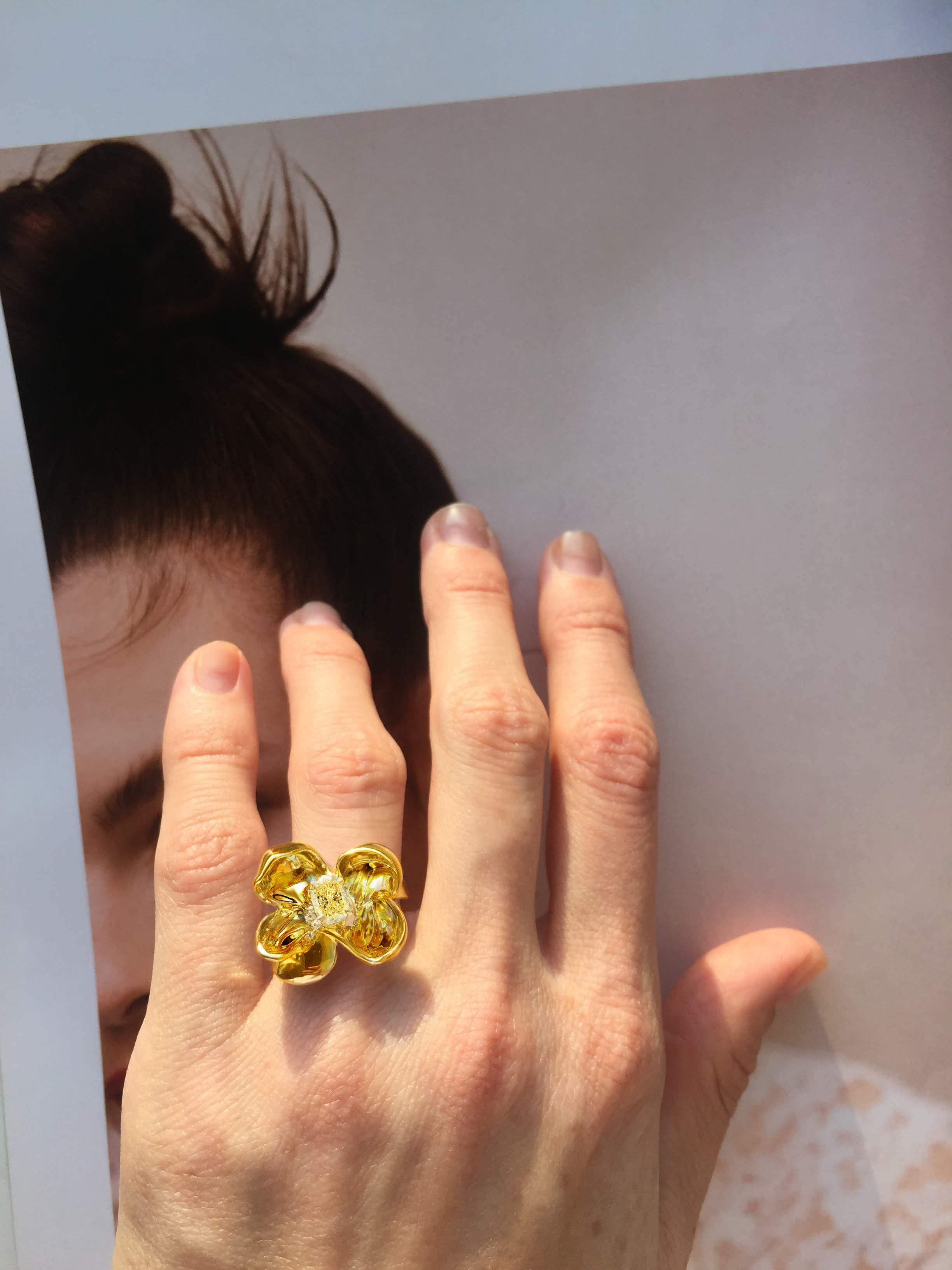 This Magnolia Flower engagement or cocktail ring is made of 18 karat yellow gold and features a yellow diamond with great characteristics. The cushion cut with 