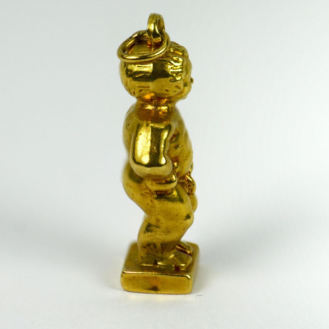  An 18 karat (18K) yellow gold charm pendant designed as the Dutch landmark, the Manneken Pis statue of Brussels. Stamped 750 with the owl mark for French import and 18 karat gold.

Dimensions: 2.5 x 1 x 0.6 cm (not including jump ring)
Weight: 2.19