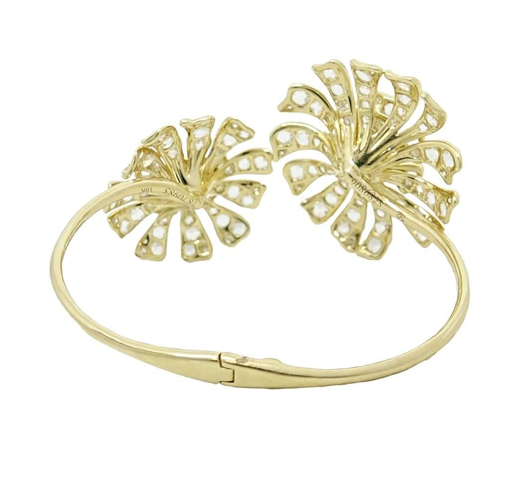 This Whimsical Bangle By Maria Canale is 18K Yellow Gold and is a Part Of The Aster Collection. This Large 54mm x 45mm Flower Bangle is About 6 Inches Around. Rose Cut Diamonds Are Set In The Petals and Details On The Flower Giving Them An