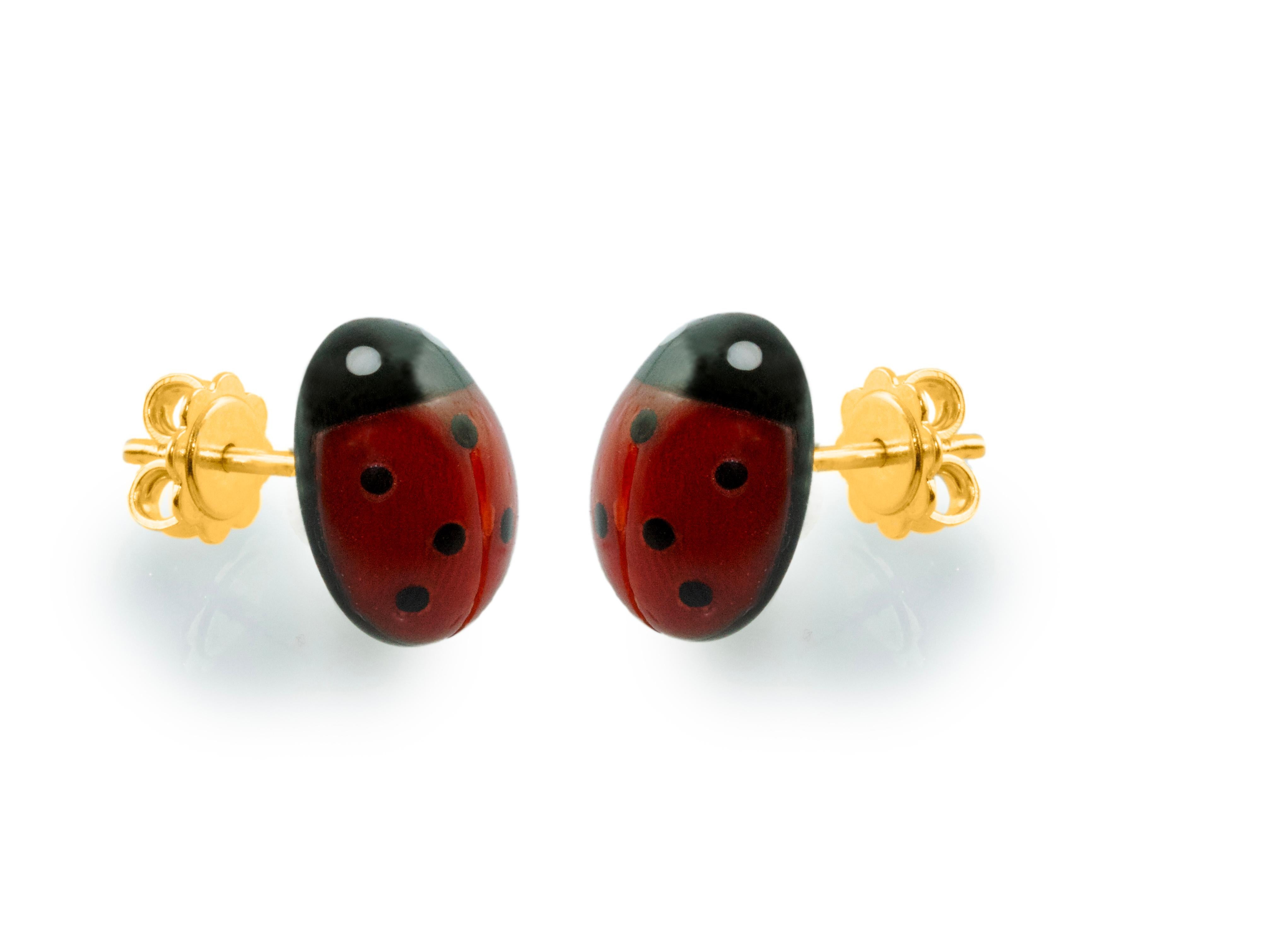 These stud earrings  are made with coral sourced in the Mediterranean and Onyx, each face have been hand-carved shaped like a ladybug with a smooth, bulging surface. 
The post in the back is made of 18k yellow gold.