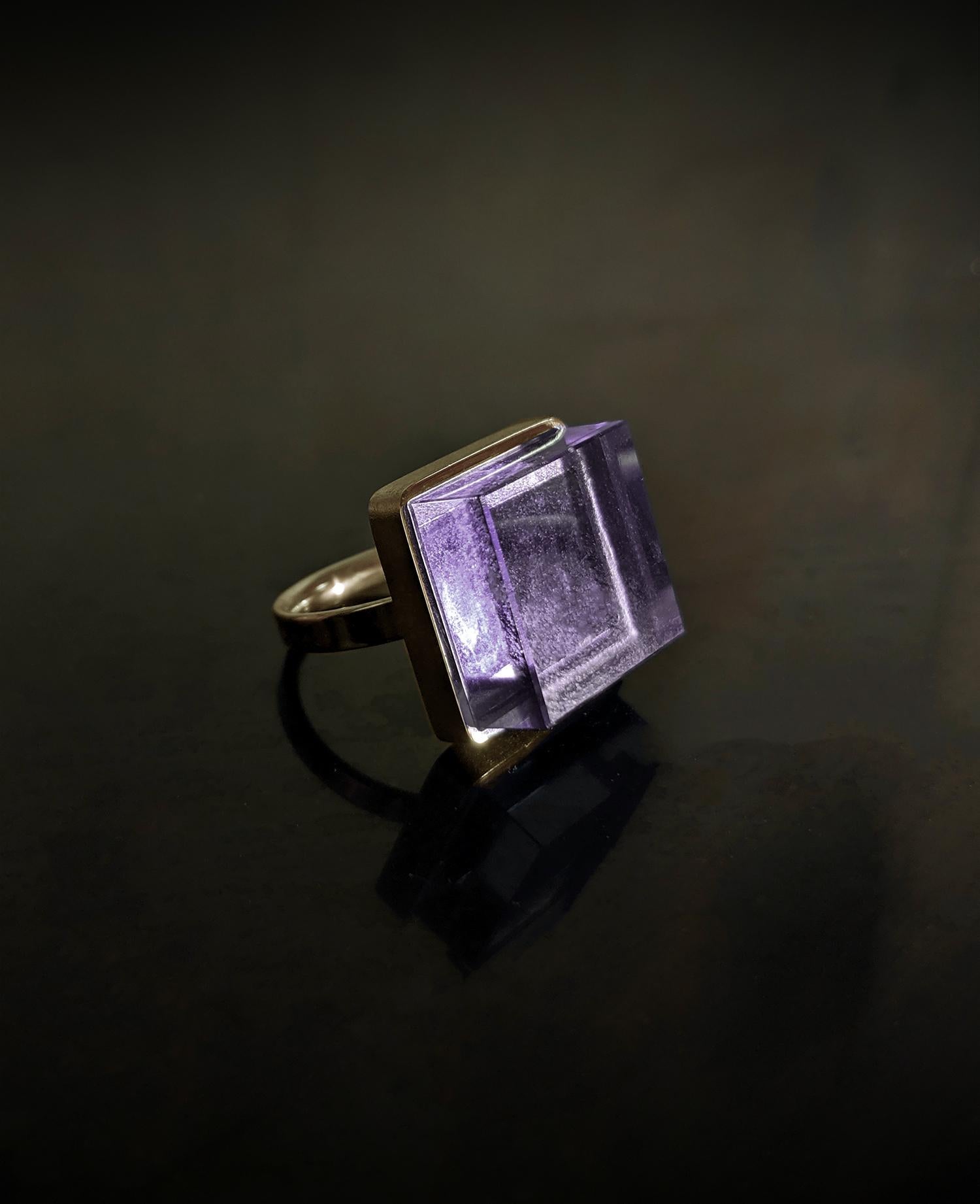 This Art Deco Style men ring is in 18 karat yellow gold with 15x15x8 mm natural vivid amethyst. It was published in Harper's Bazaar and Vogue UA. 

The ring reflects the art deco spirit and fits to women and men. It inspires the architects,