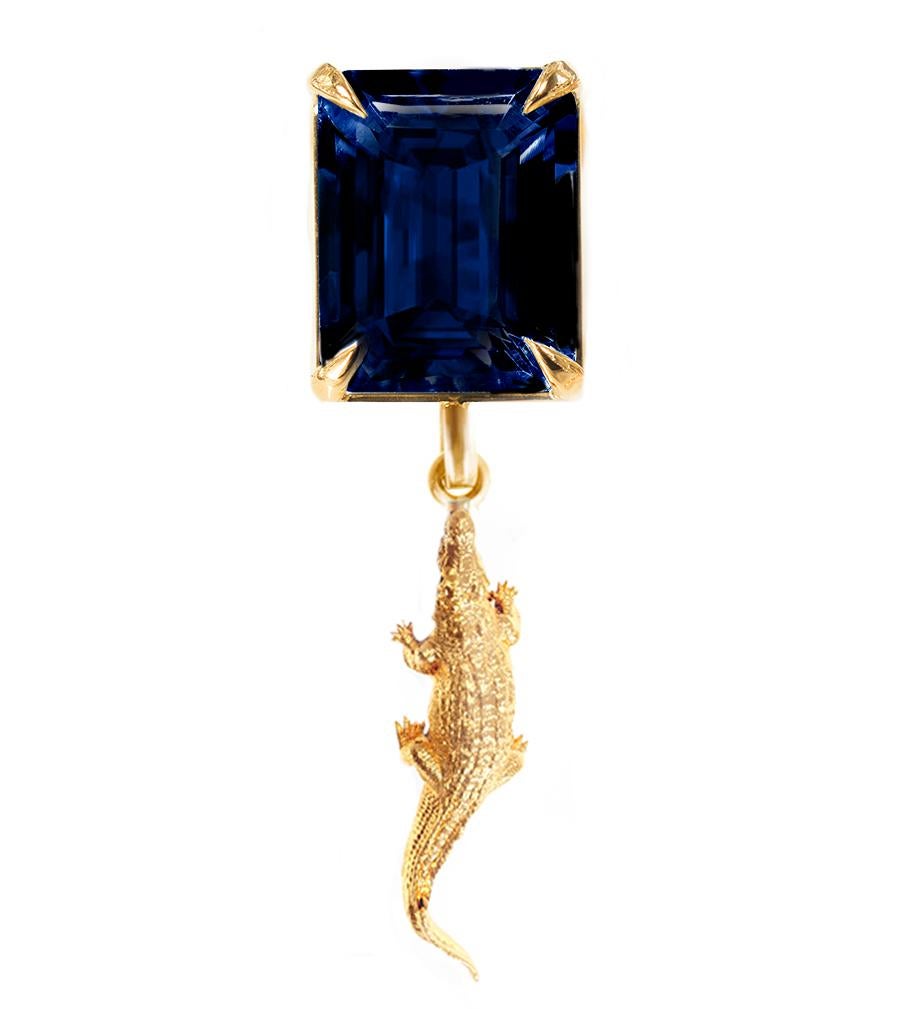 This contemporary Mesopotamian pendant necklace is made of 18 karat yellow gold and features a natural dark blue sapphire (octagon cut). 
It belongs to the new Mesopotamia collection, designed by the oil painter from Berlin, Polya Medvedeva. 