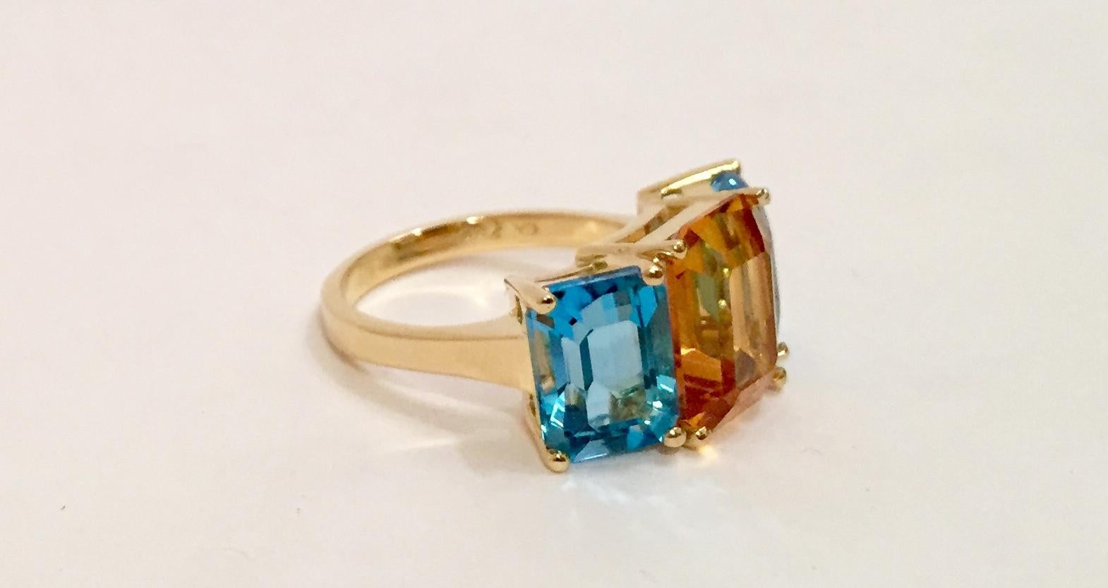 18 Karat Yellow Gold Mini Emerald Cut Ring with Orange Citrine and Blue Topaz.

This mini emerald cut ring can be made in any ring size and with any colored semi precious stone combination.  The Ring is sized for each client.

The ring Measures