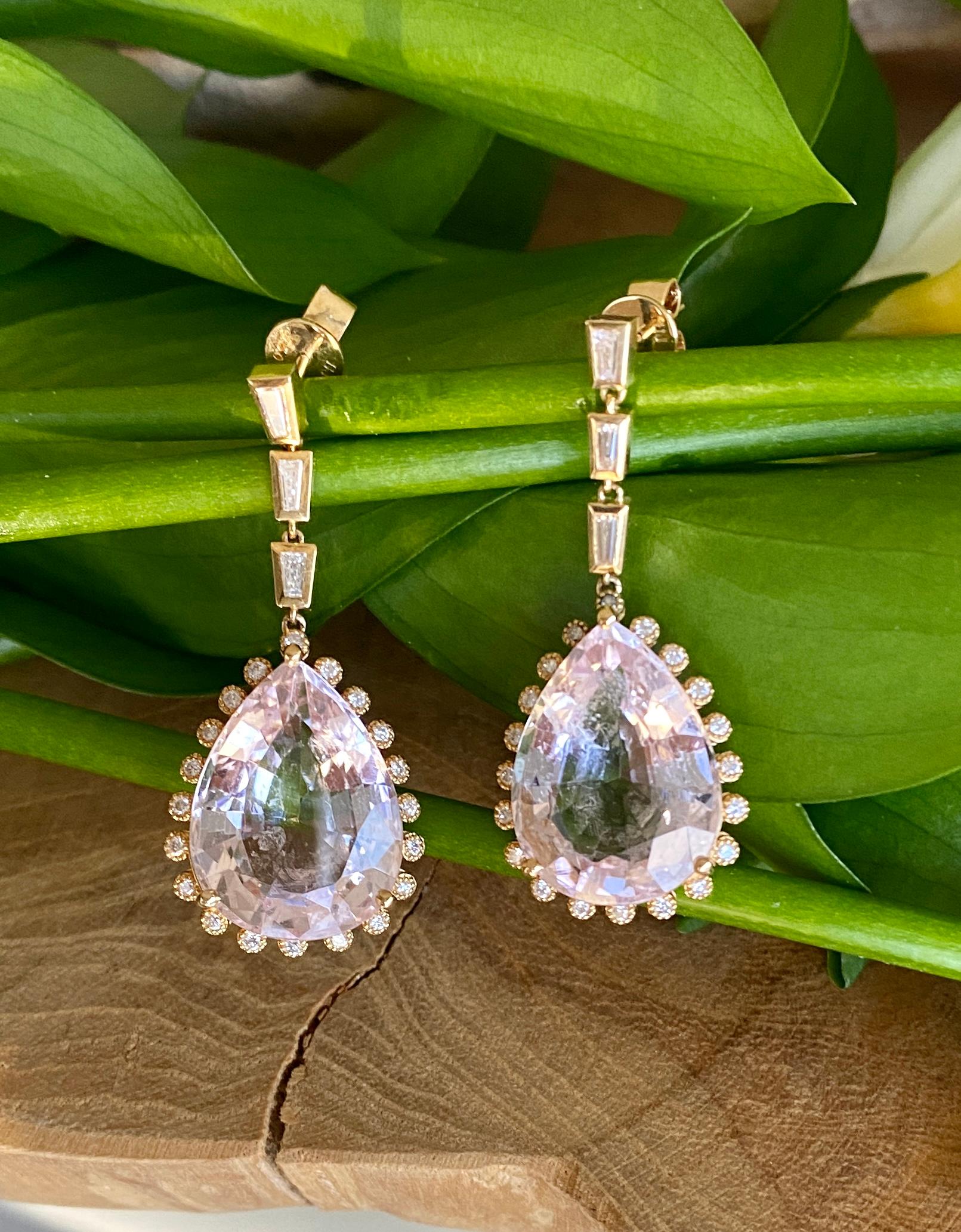 Teardrop shaped faceted morganites surrounded by round diamond accents and dangling on a trio of tapered diamond baguettes, handcrafted in 18 Karat yellow gold.

These stunningly elegant morganite and diamond earrings are the perfect holiday jewels.