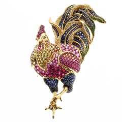 Broche coq en or jaune 18 carats et saphir multicolore