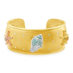 Manschettenarmband aus 18 Karat Gelbgold mit mehrfarbigem Saphir und Diamant Meeresleben